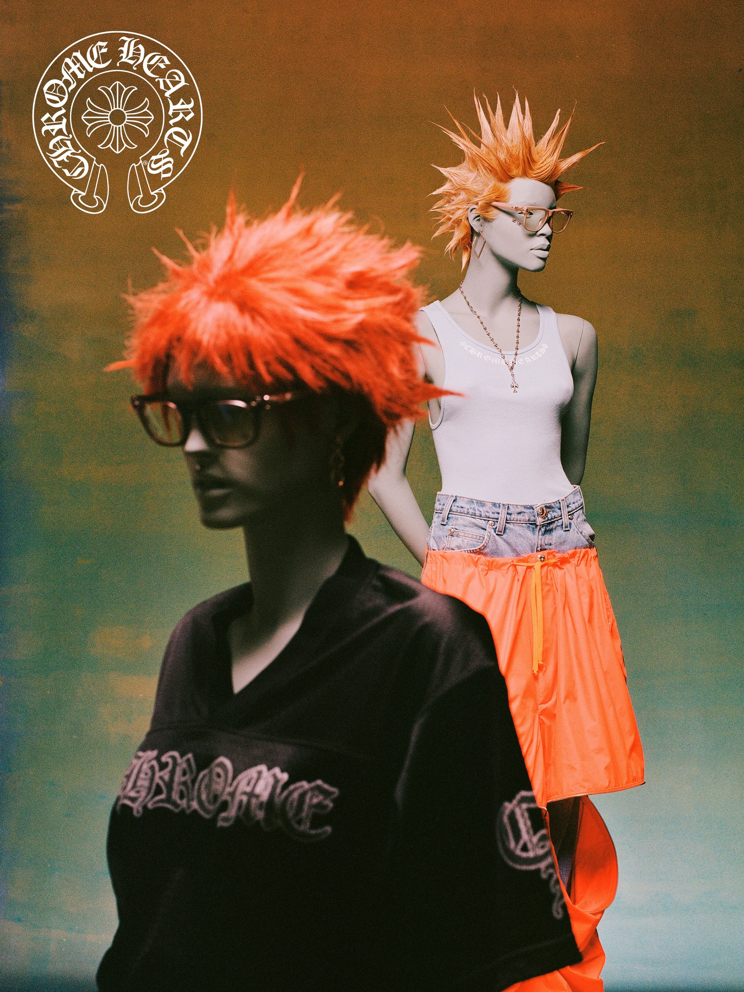 Two mannequins with bright orange spiked hairstyles and glasses, one in a black top and the other in a white tank top and orange shorts, against a multicolored background with a circular logo in the top left corner.