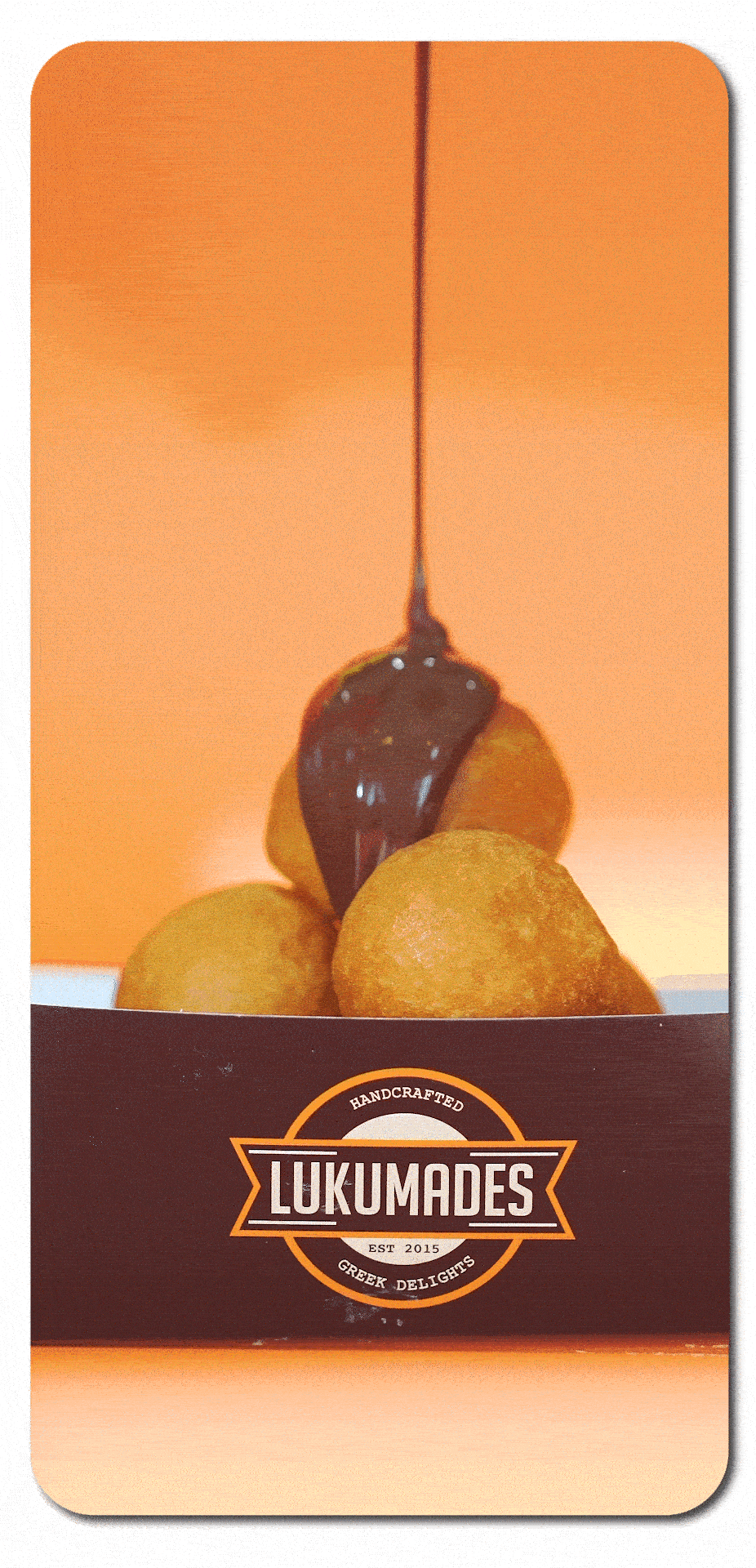 Lukumades Greek donuts with chocolate sauce pouring over them.