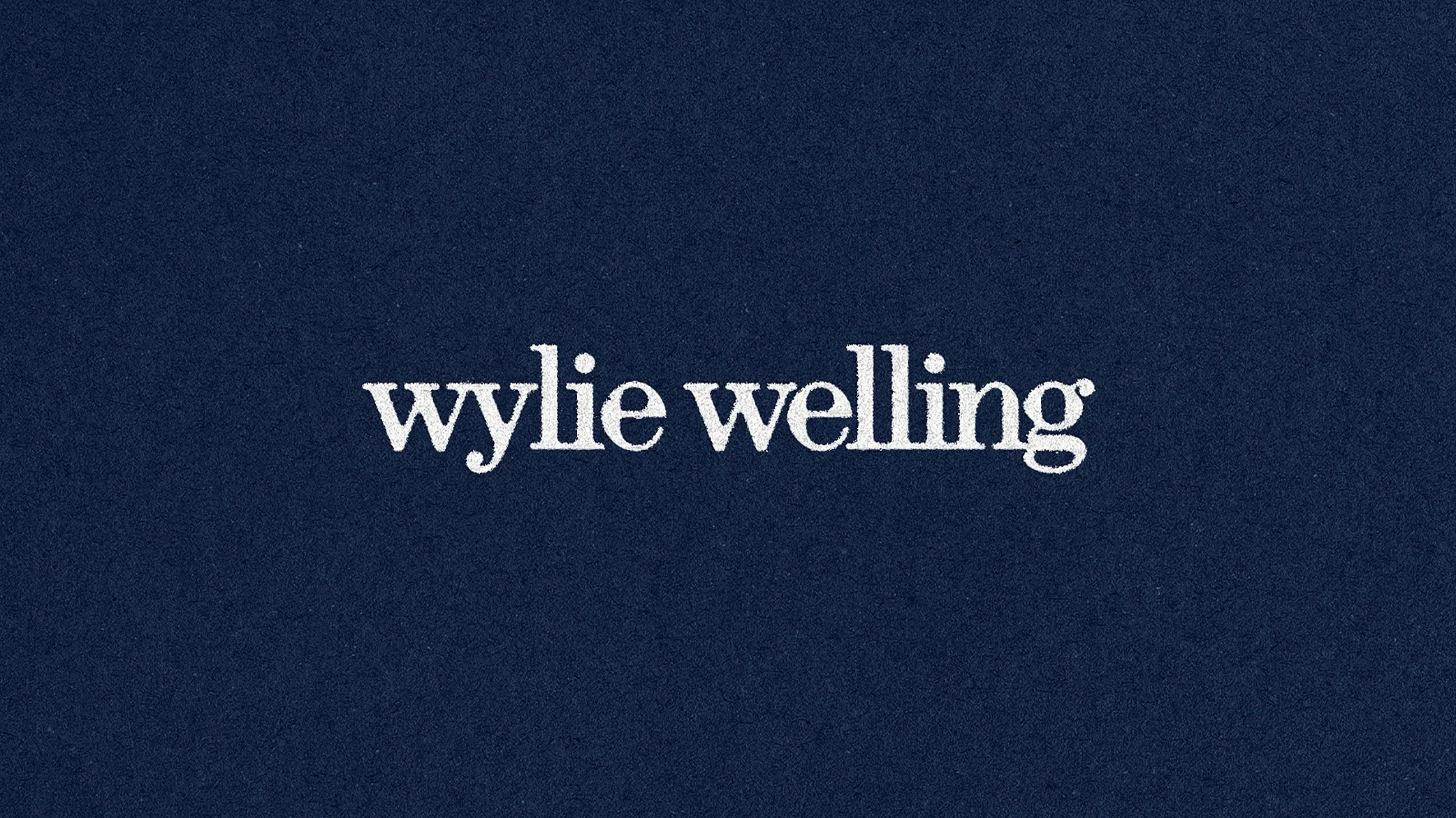 Wylie Welling fashion brand logo with elegant serif typography on navy background, branding and visual identity design by Scorpion Rose Studio and Lafayette American.