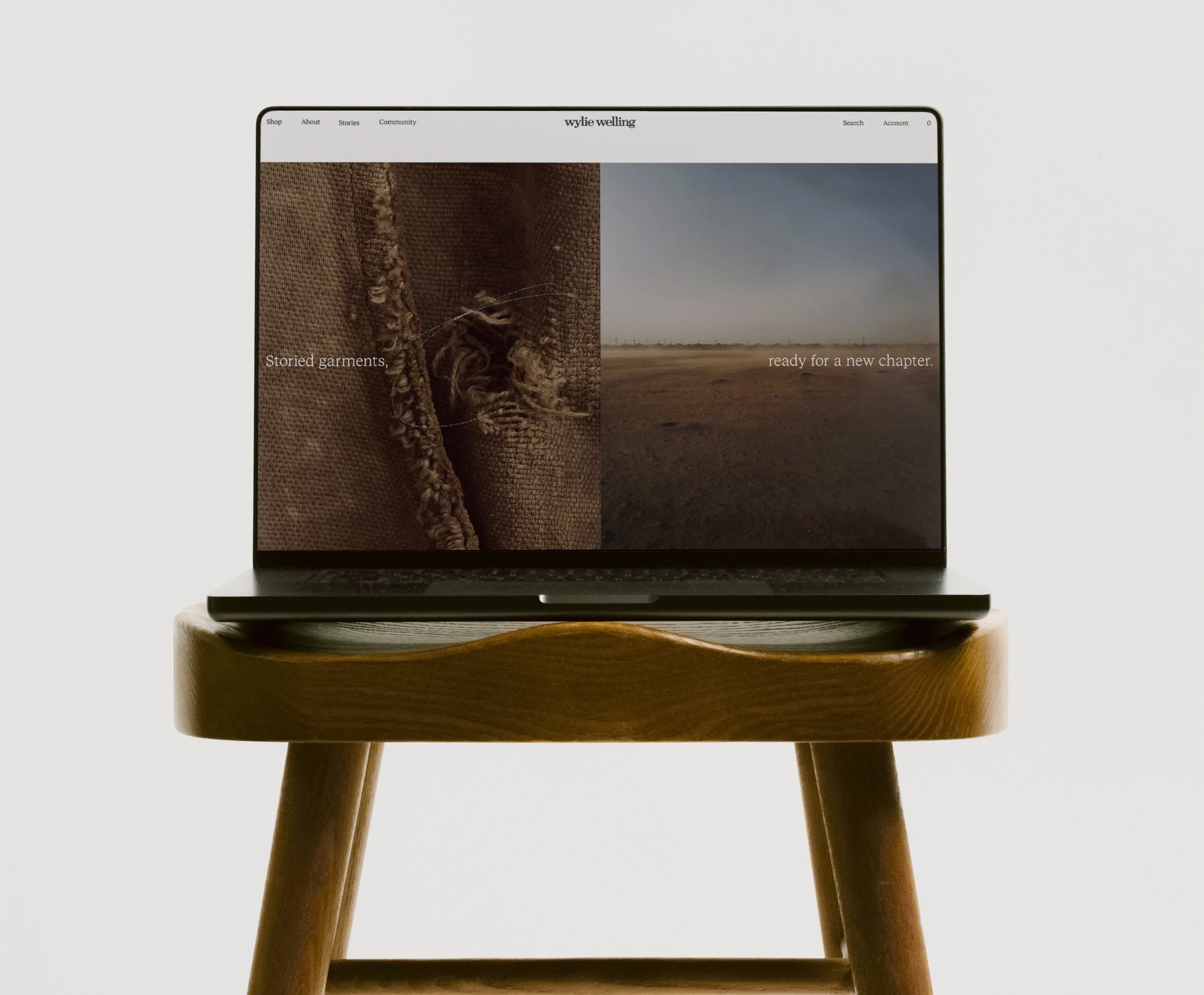 Website by Scorpion Rose Studio and Lafayette American for Wylie Welling on a laptop, sitting on top of a wood stool. The screen shows the interface and the headline "Storied garments, ready for a new chapter."