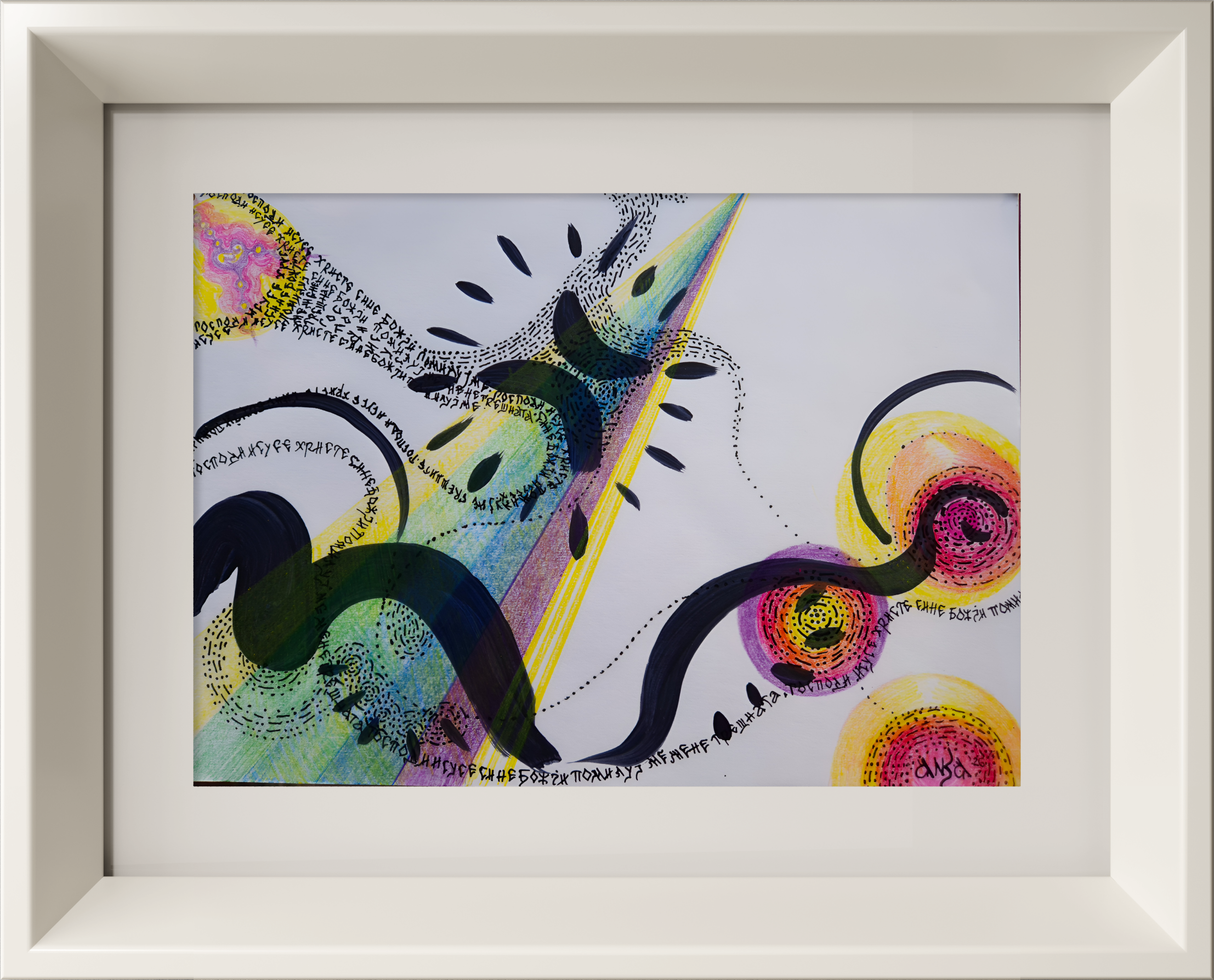 Close-up of an abstract artwork with colorful patterns, black ink dots, and handwritten text in black ink on a white background, framed in a light-colored frame.