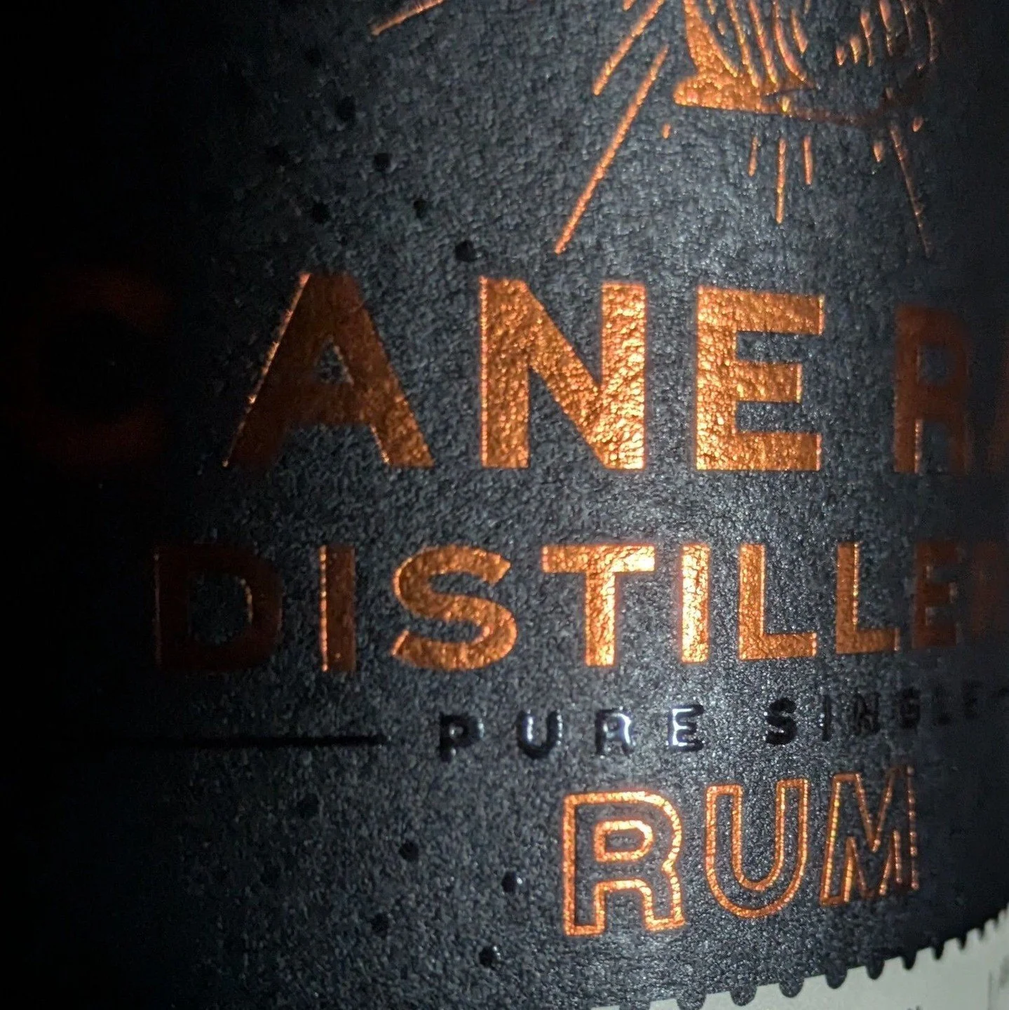 The copper-toned artwork on our label is applied using hot foiling. A metal die presses metallic foil into the paper under heat and pressure, bonding the foil directly to the surface. 

It's one of of several techniques used in the creation of our la