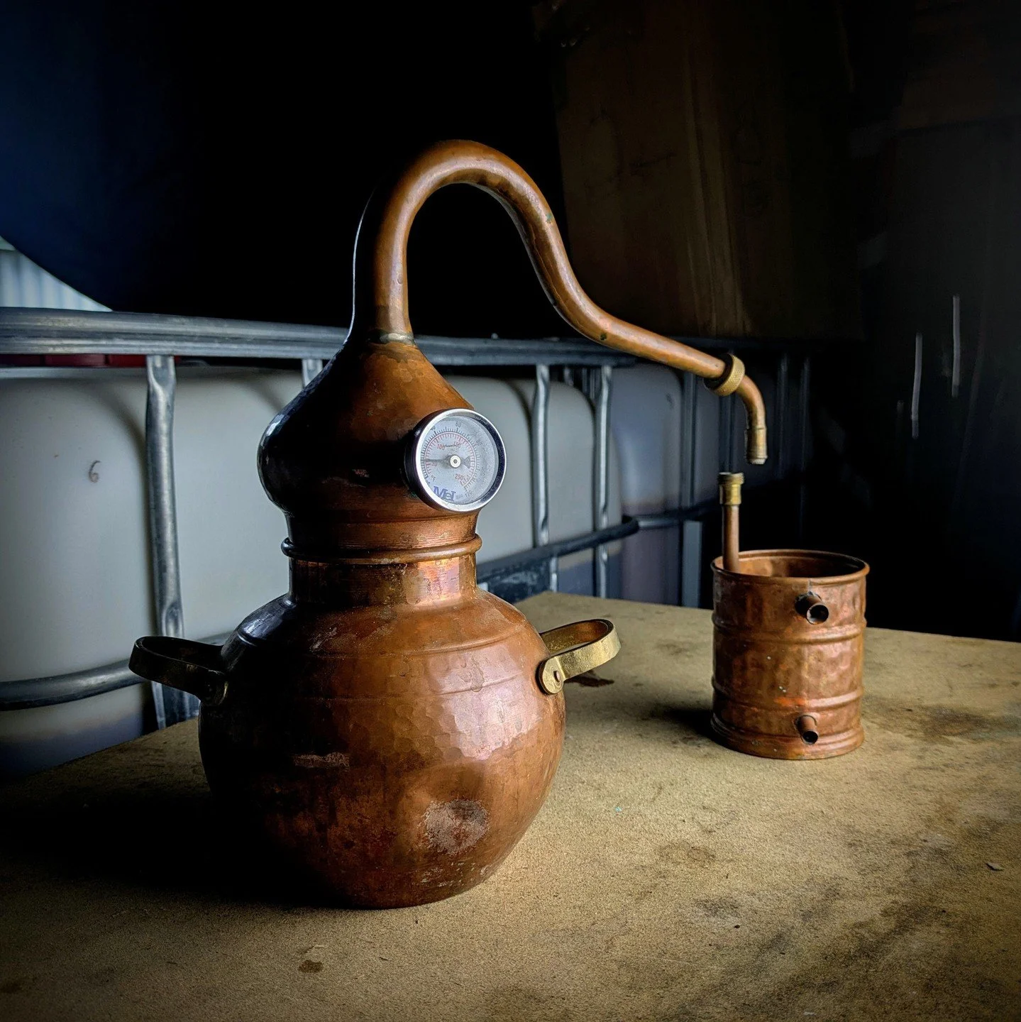 Our little ornamental still had been neglected for a while...

The copper has reacted to form a beautiful blue compound (possibly a sulphate) along the inside surface.
