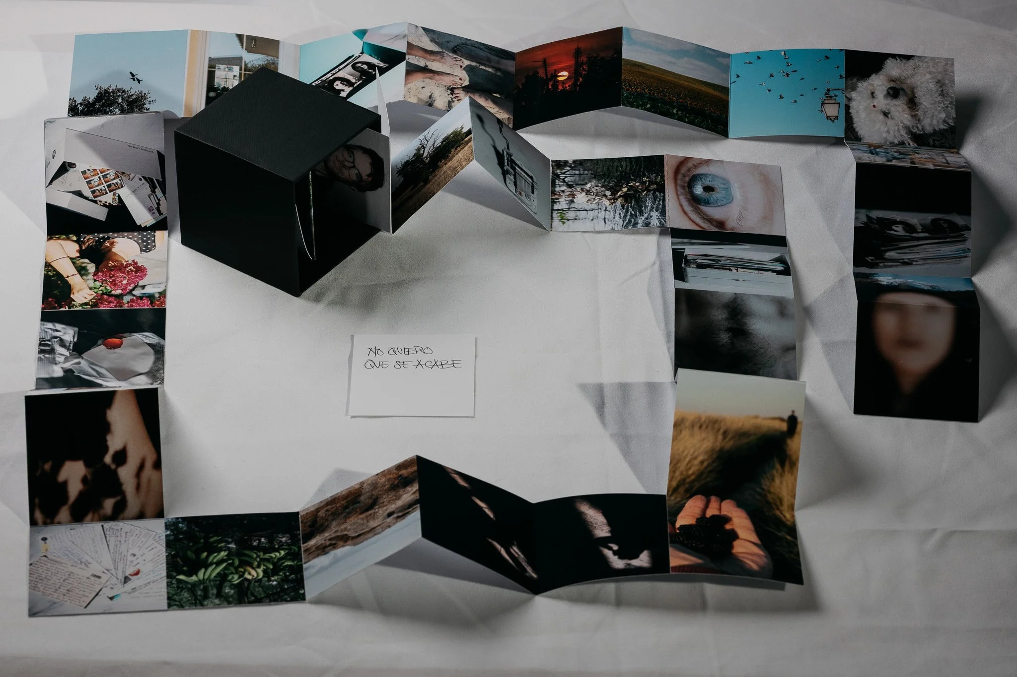 Detail of accordion photo object with archival images and keepsakes
