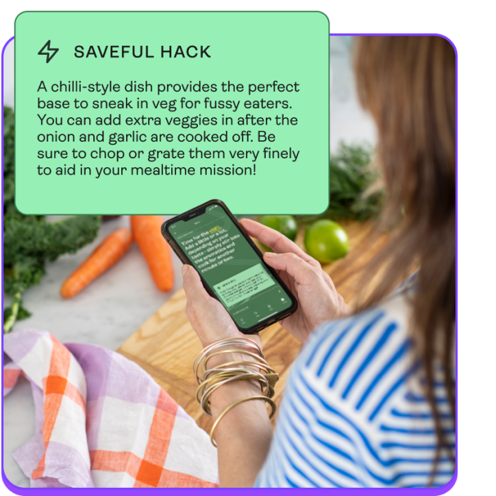 An over the shoulder shot of a woman looking at a saveful recipe on her phone