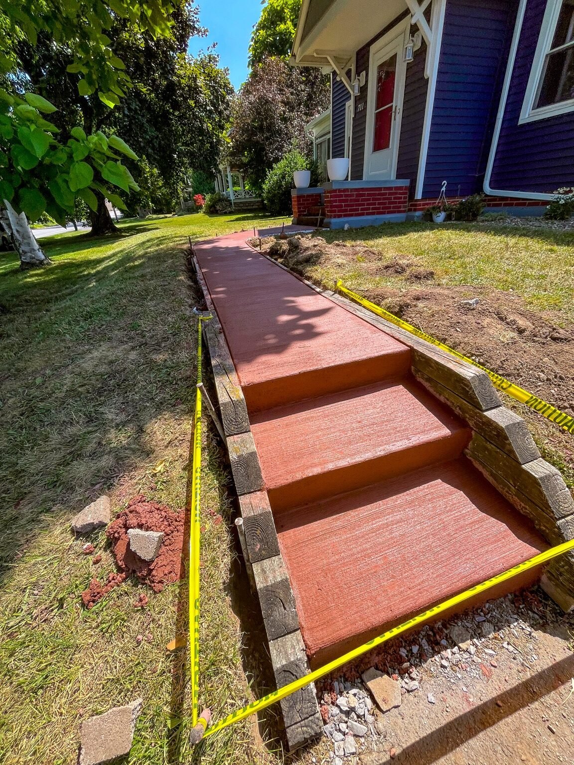 Henrietta, NY — Brick Red 2 broom-finished concrete steps and matching walkway.