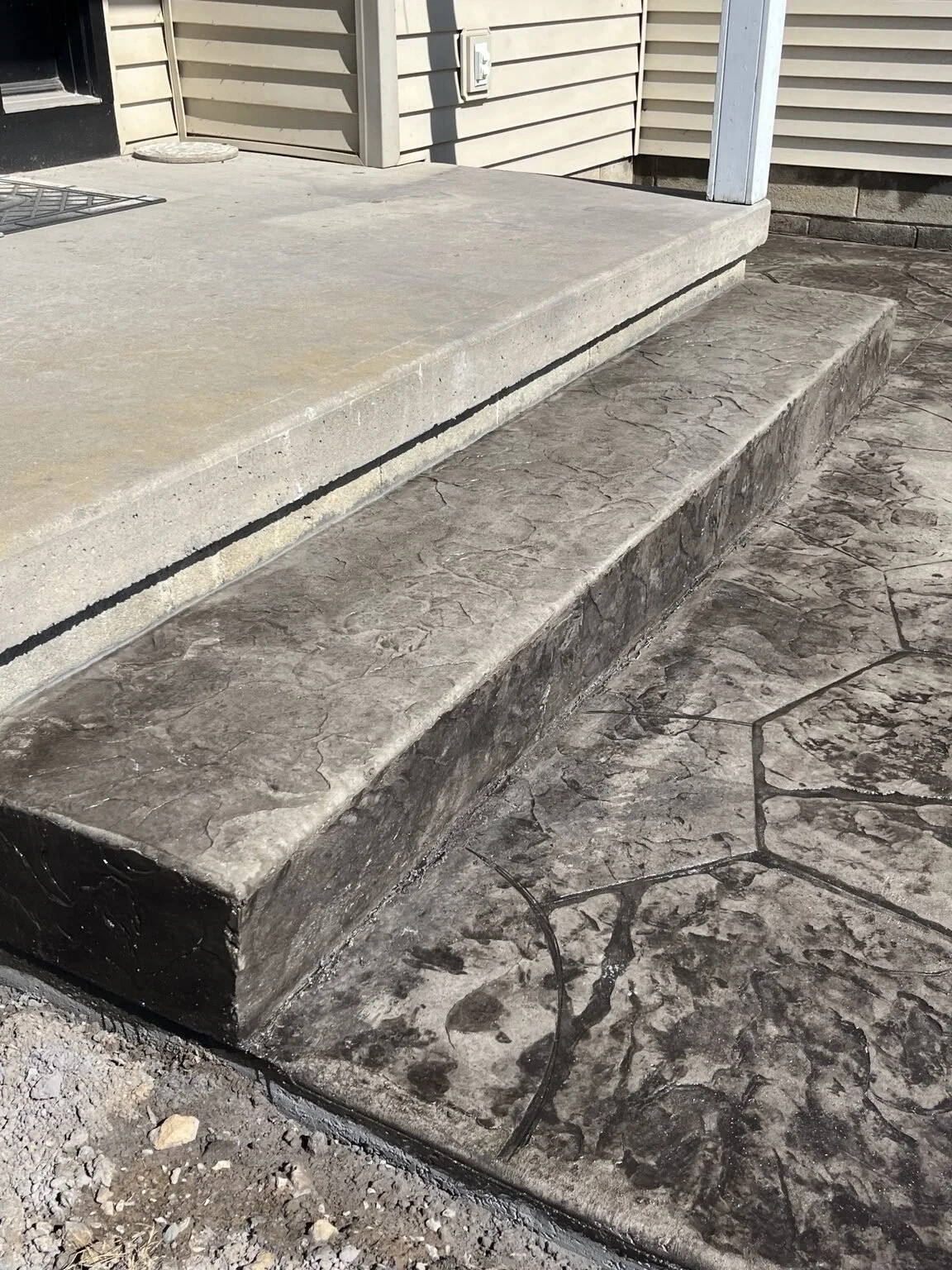 Irondequoit, NY — stamped concrete porch step coordinated with the surrounding decorative concrete.