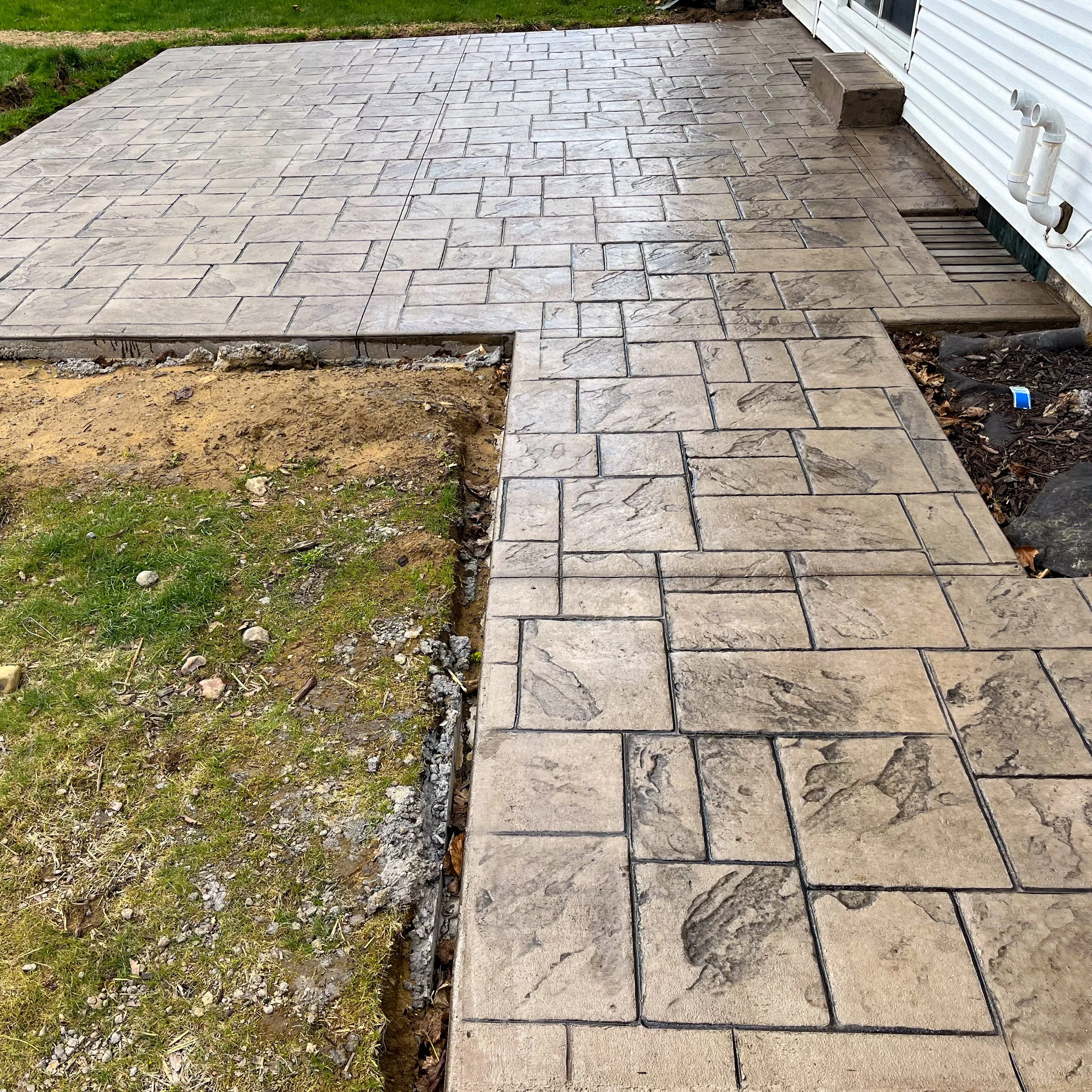 Stamped patio and sidewalk with a step in Rochester, NY