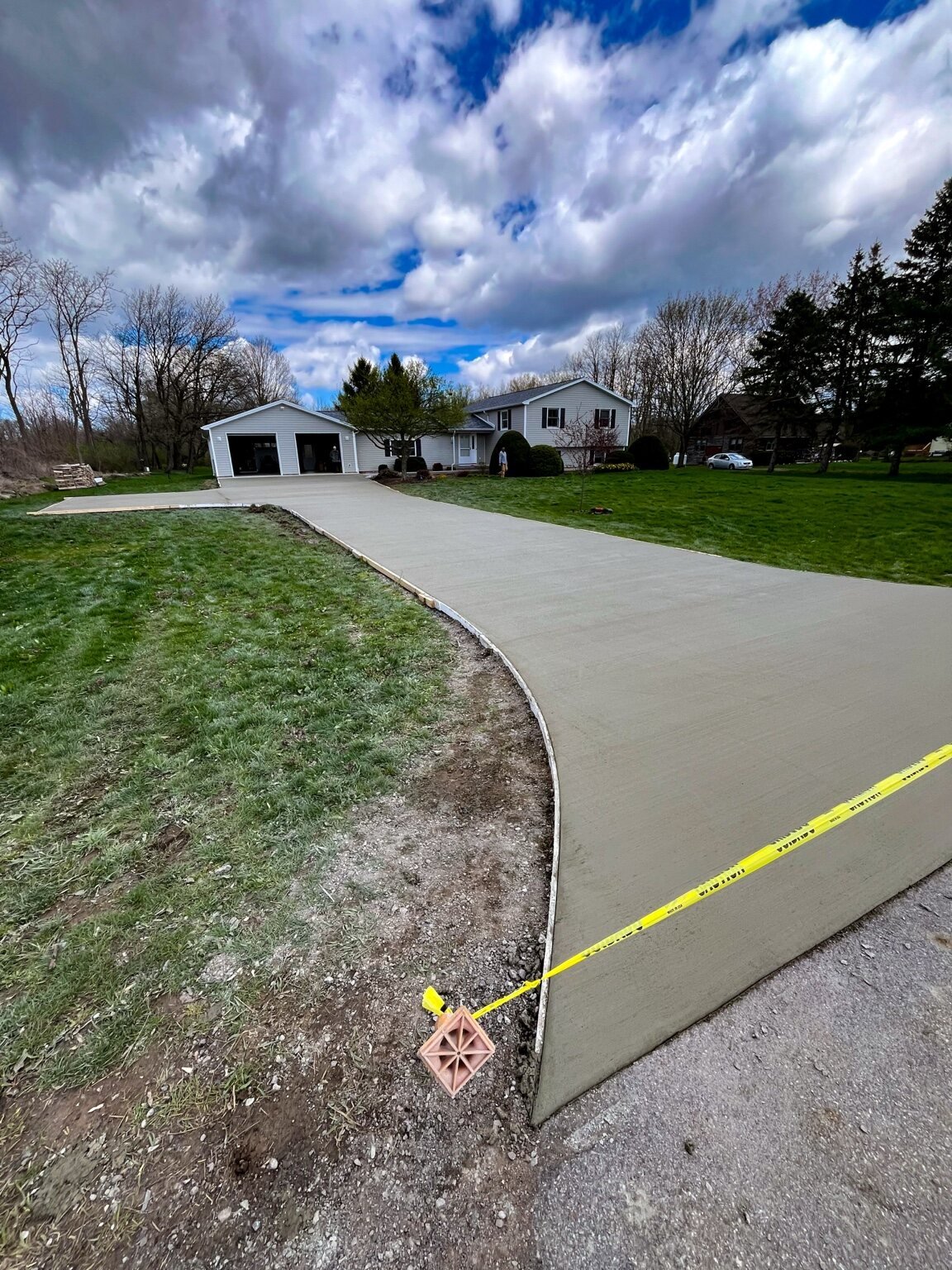2,000+ sq. ft. concrete driveway with a large turnaround in Churchville, NY.