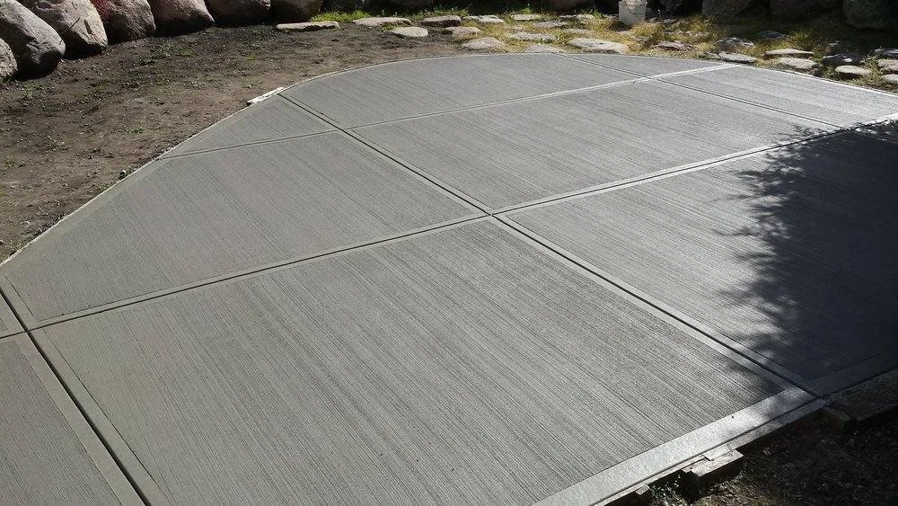 A rounded concrete patio with a broom finish