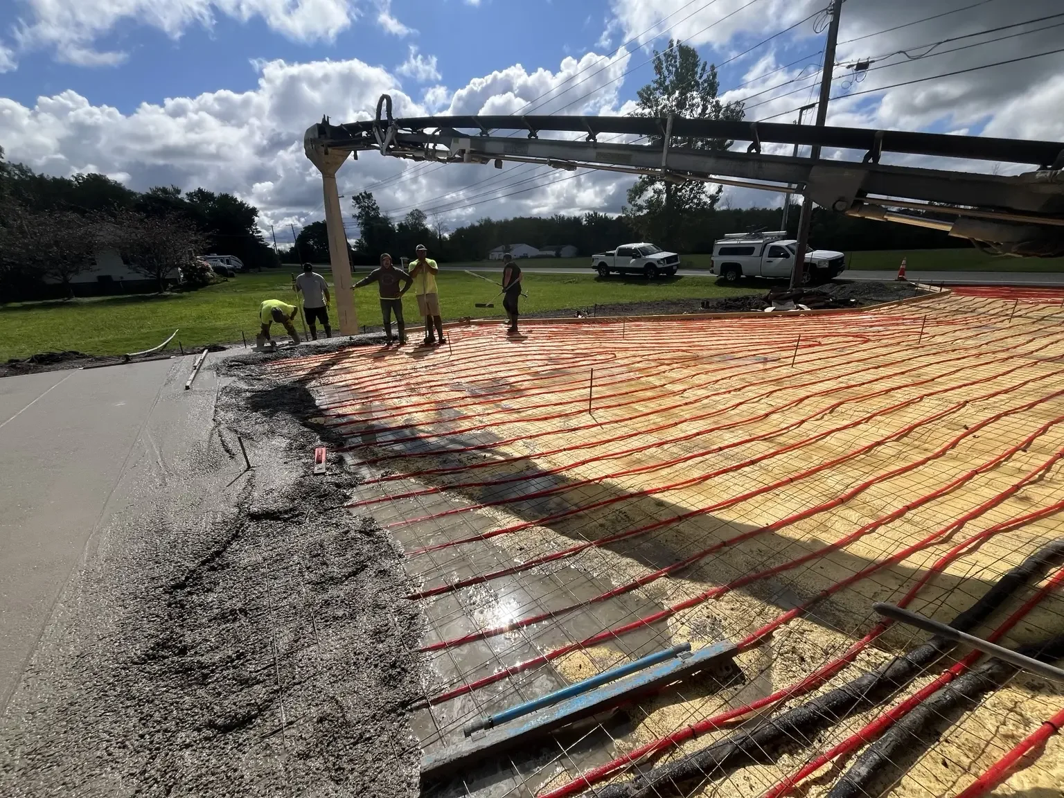 Concrete being placed over hydronic tubing for a heated driveway project in Webster, NY