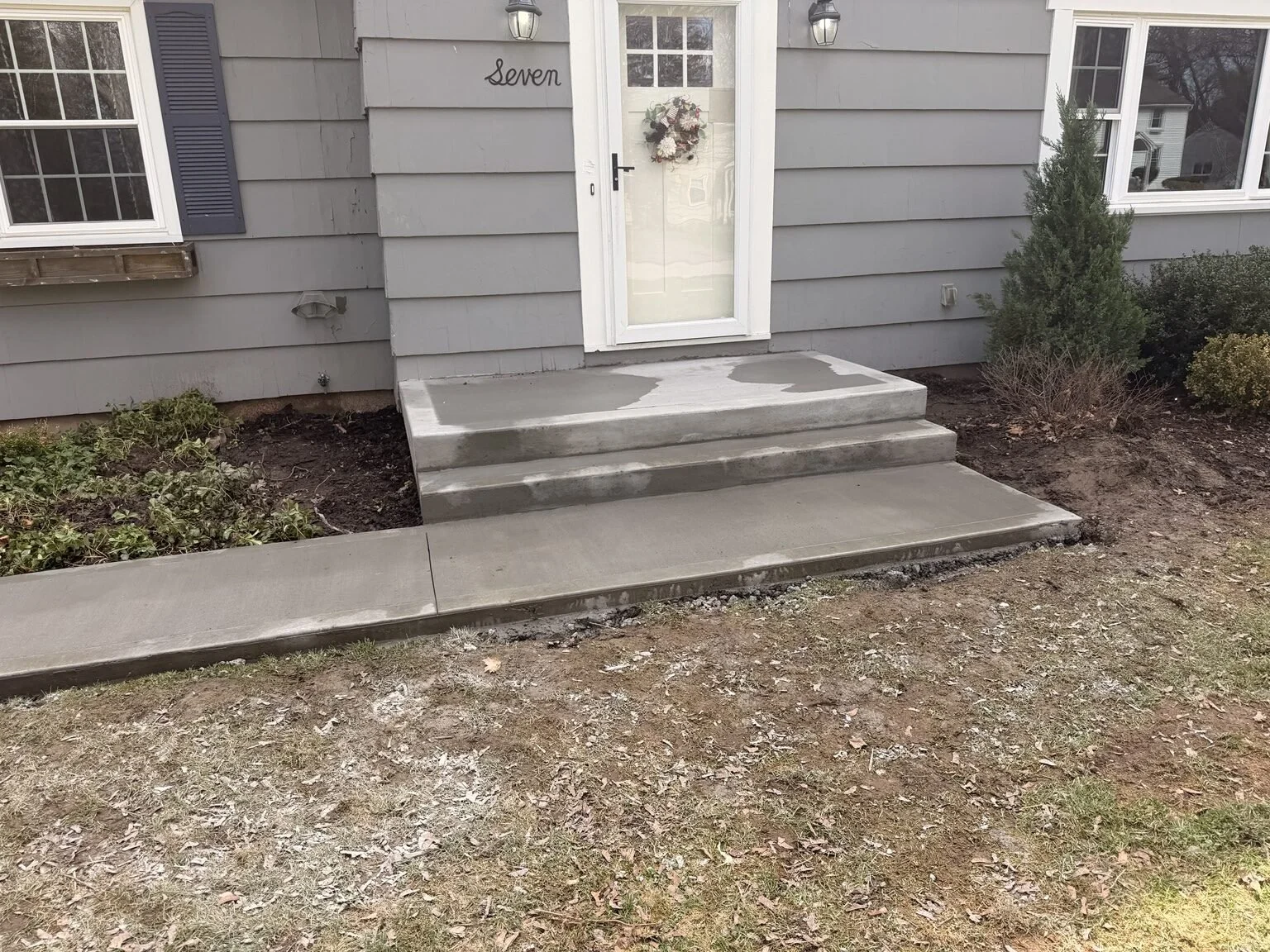 Brighton, NY — broom-finished concrete entry steps, landing and connecting walkway.