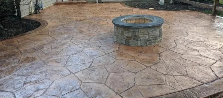 Flagstone-pattern stamped concrete patio installed by Rochester Patio Pros
