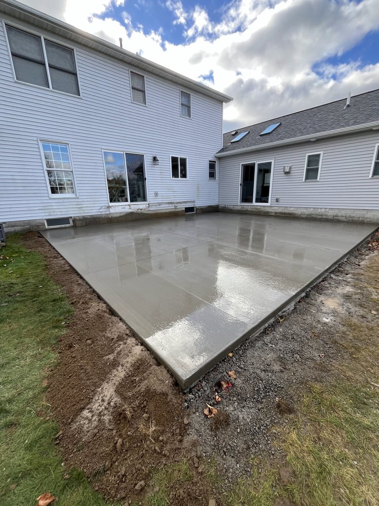 Broom-finished concrete patio installed by Rochester Patio Pros