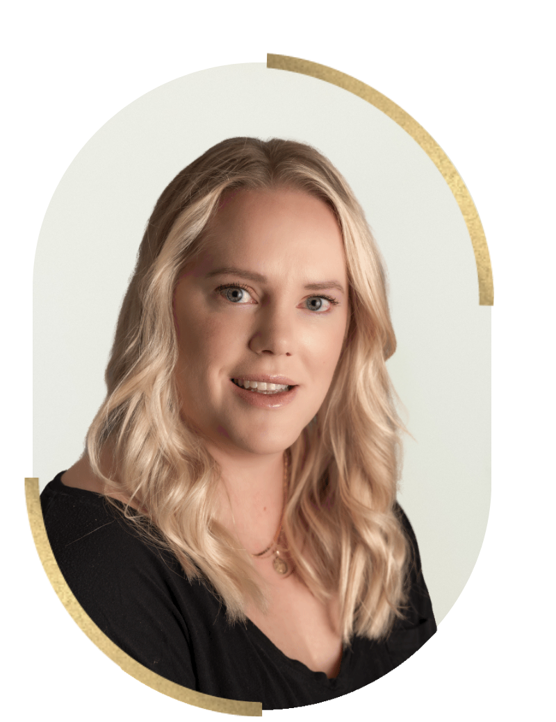 A portrait of a woman with long wavy blonde hair wearing a black top, looking at the camera with a slight smile.