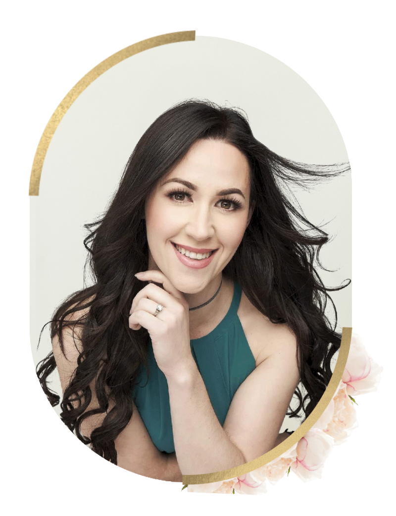 A smiling woman with long dark hair wearing a teal top, resting her chin on her hand, in front of a plain white background with floral and gold decorative elements.