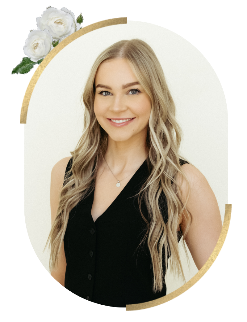 A smiling young woman with long, wavy blonde hair, wearing a sleeveless black top and a small necklace, posing against a white background with a floral border.