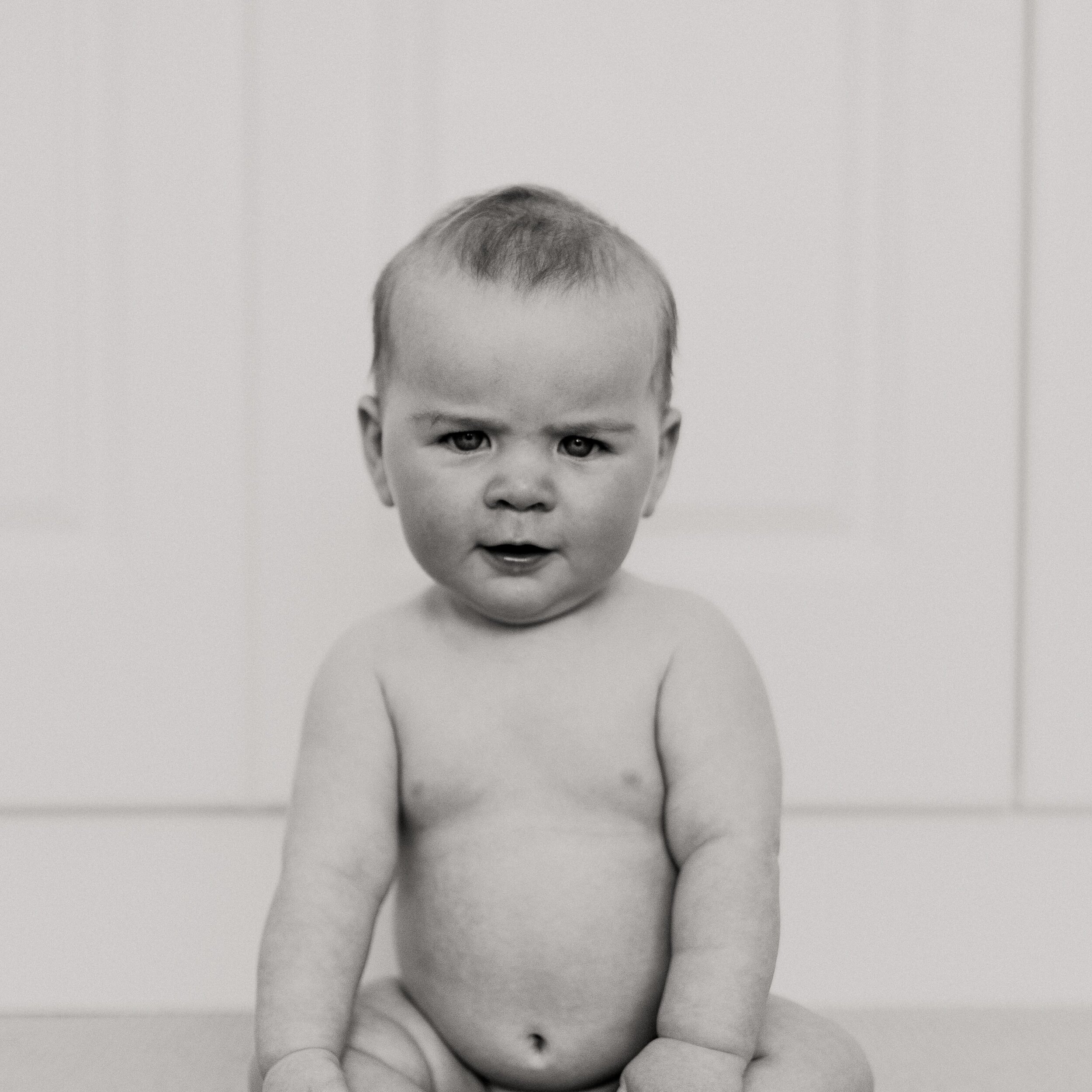 One of my favourite photographs I&rsquo;ve taken. Paddy was a deliciously plump little 6 month old and showed his spirit fiercly from a young age, as you can see 🤣. That age when they first start sitting and they have rolls on on rolls on rolls. My 