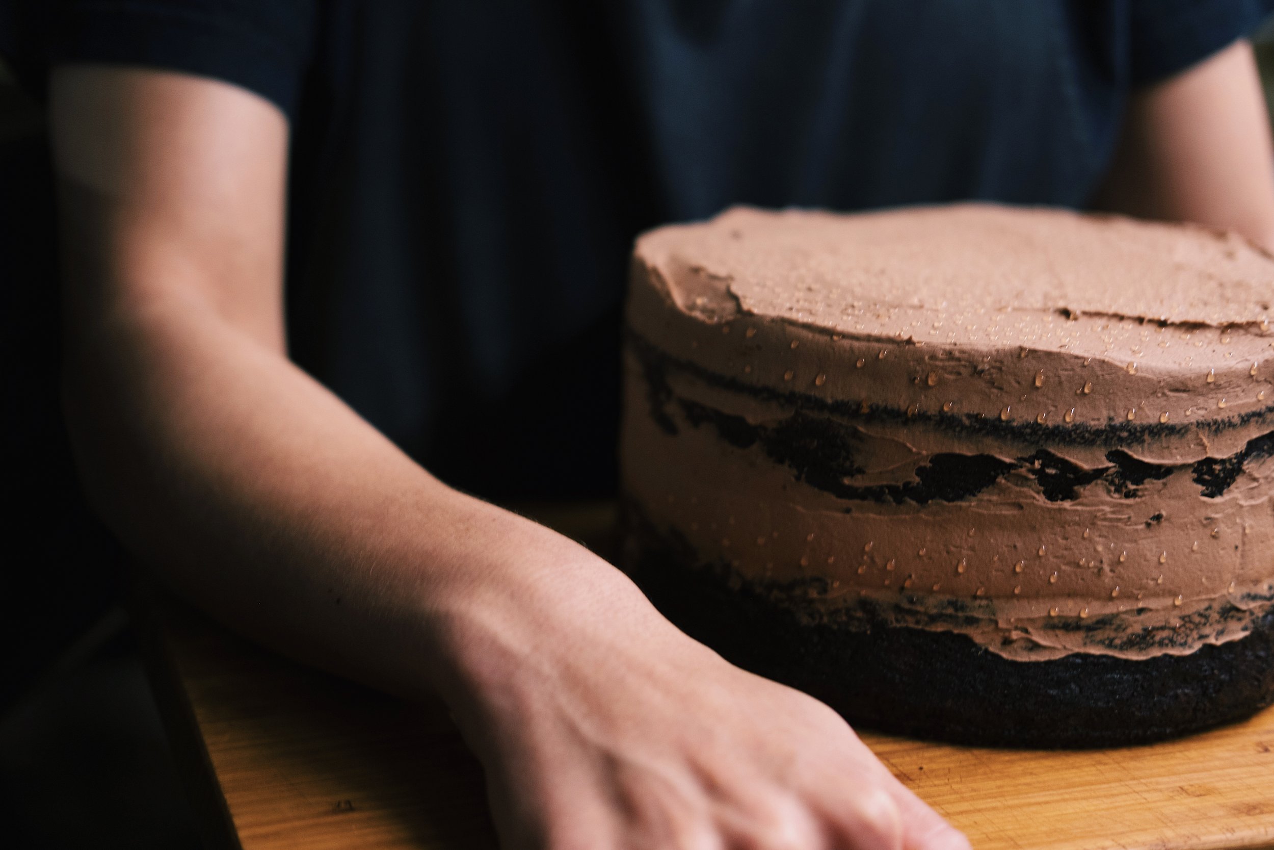 baker holding double chocolate cake
