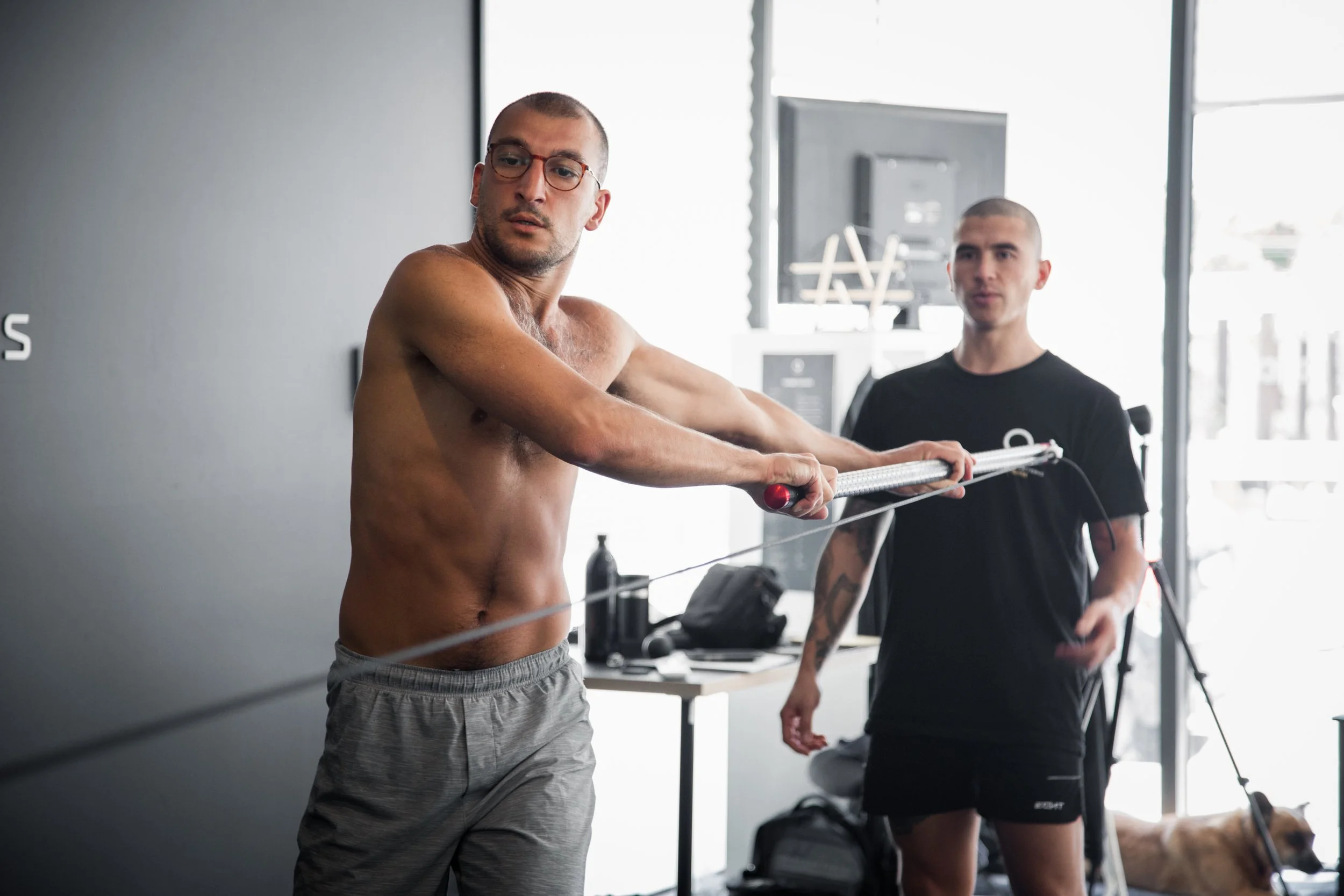 Functional Patterns Melbourne trainer assisting a client with exercises to improve movement patterns, posture, and overall functional fitness.