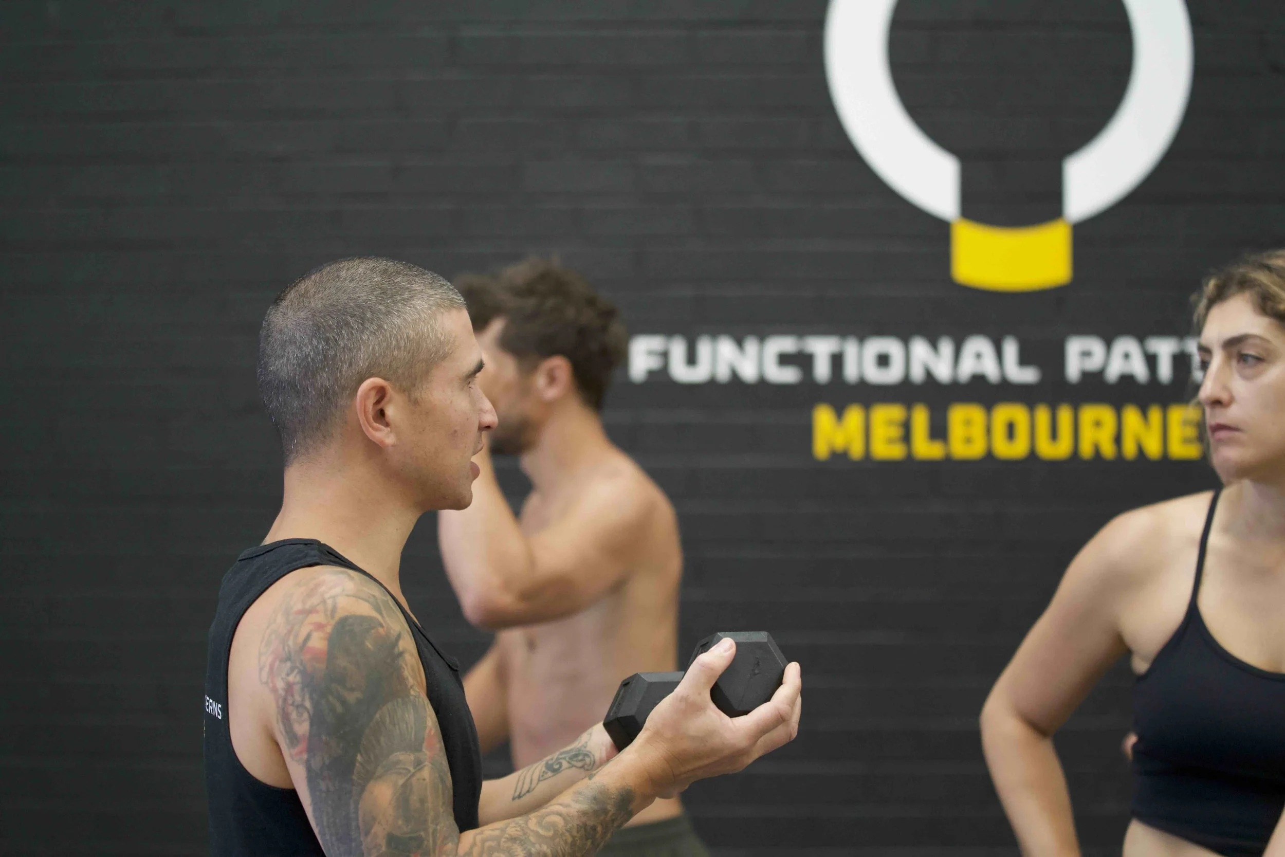 Functional Patterns Melbourne trainer guiding client through scoliosis corrective exercise to enhance movement efficiency.