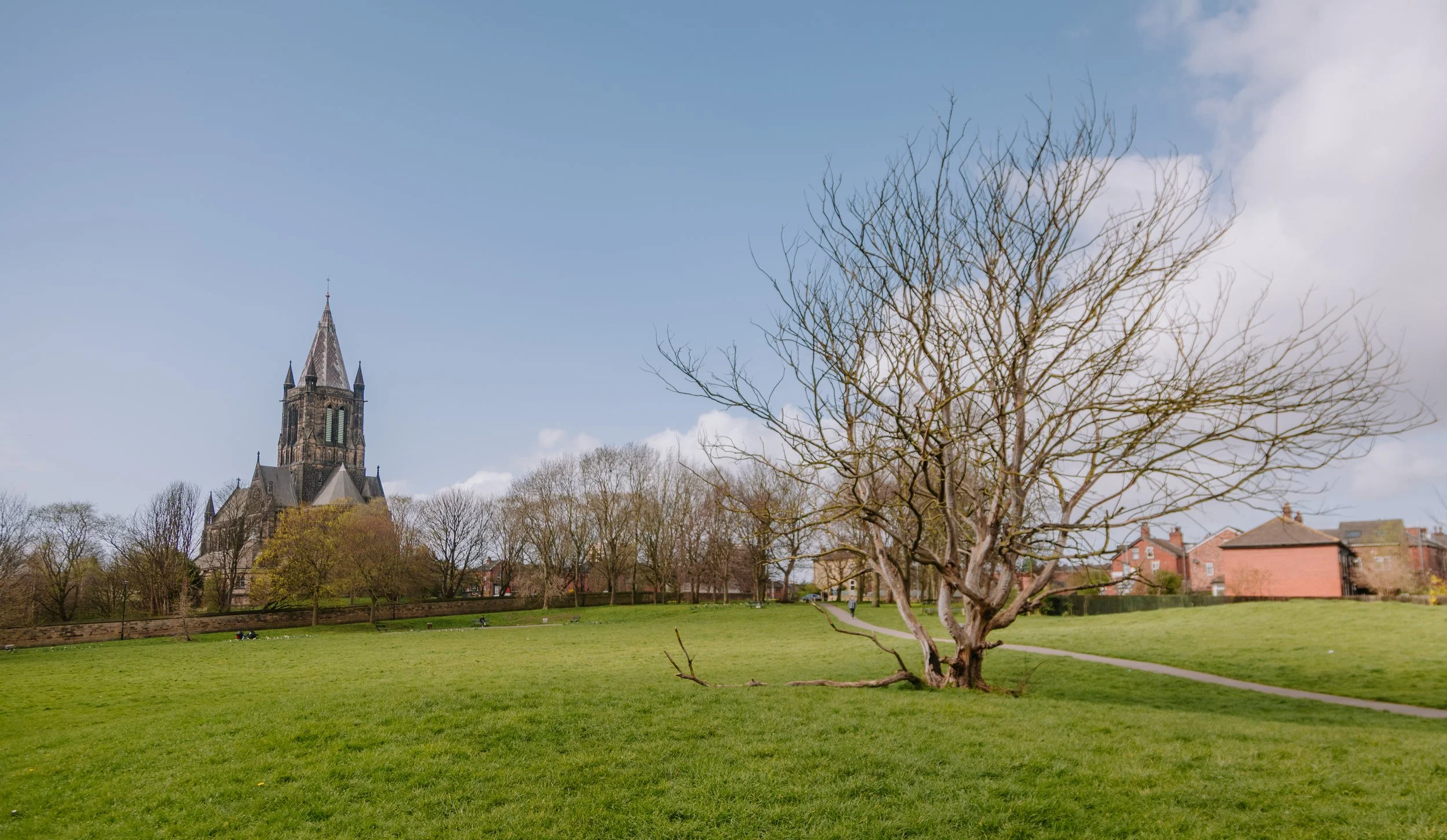 Park in Armely, Leeds with church and trees in the background