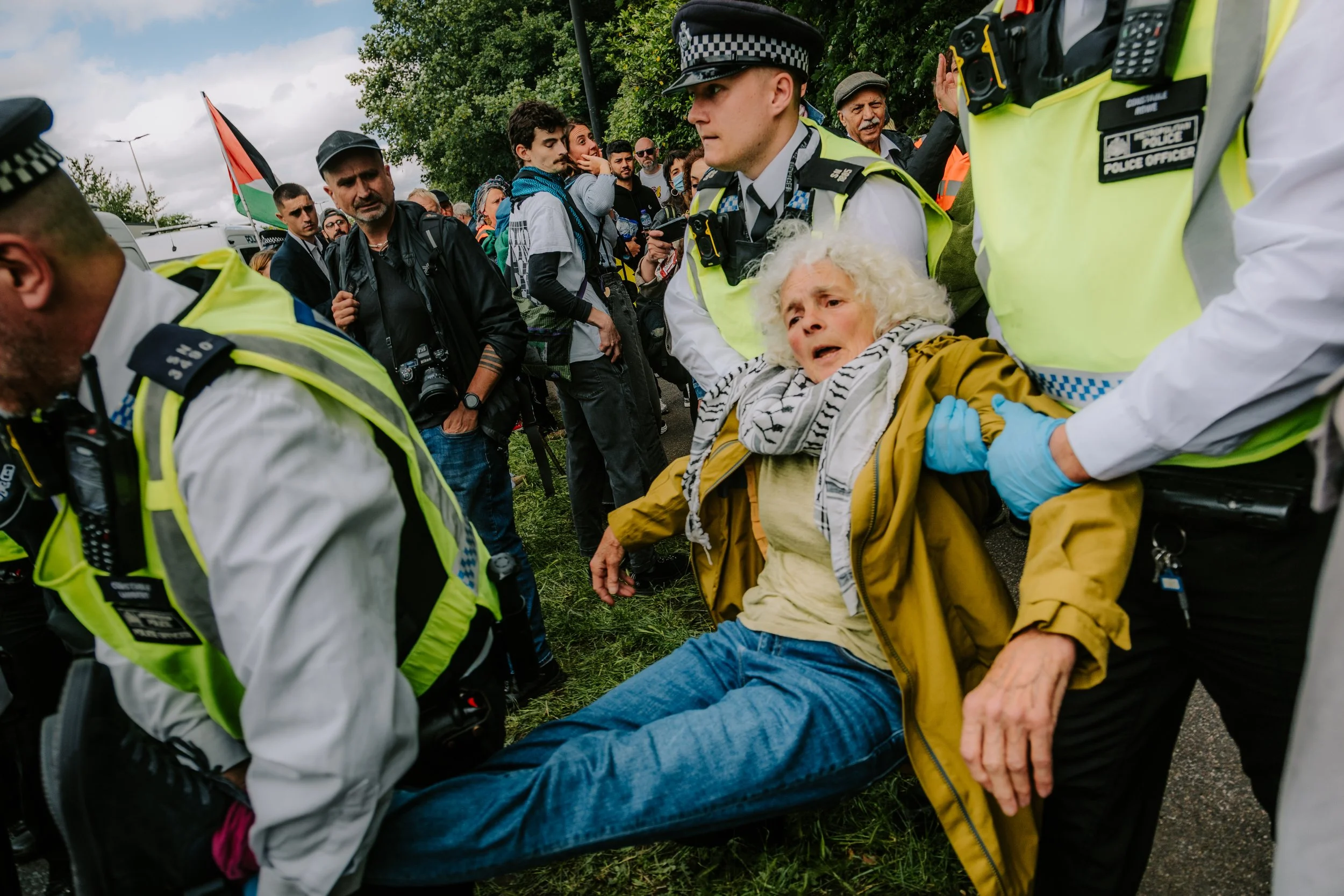 Police carry away an elderly woman arresting her outside Woolwich Crown Court for holding a sign in support of proscribed group Palestine Action. 