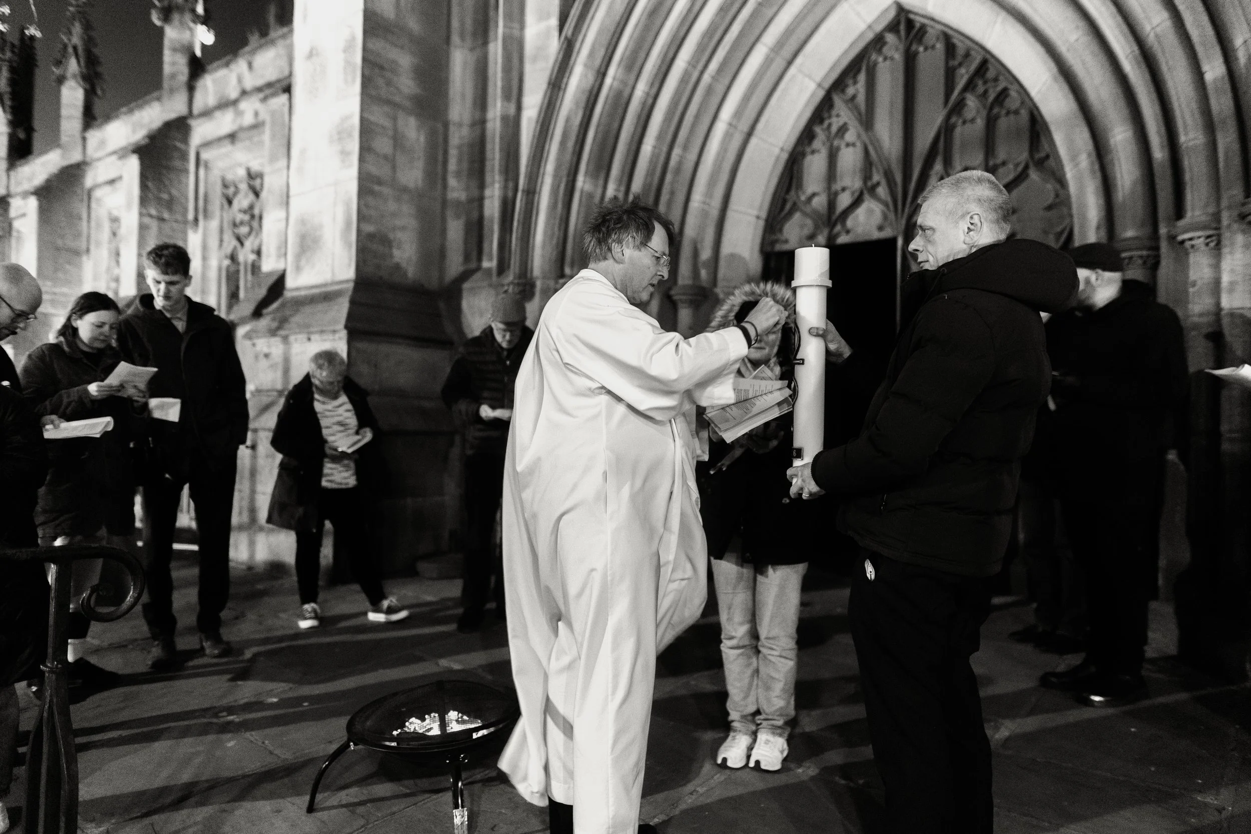 People gather outside a leeds minster in the early hours of easter sunday morning to light the easter candle