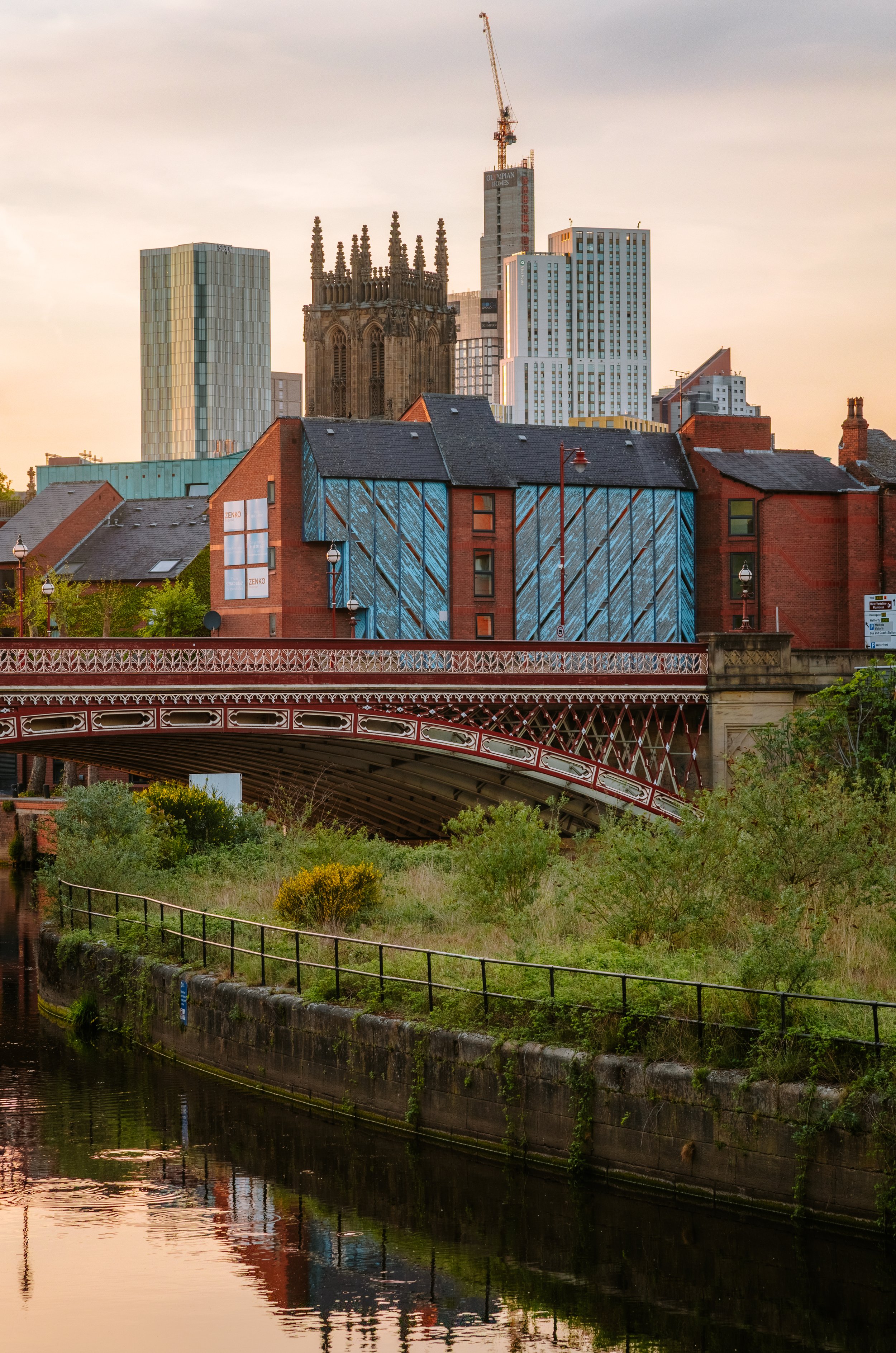 Leeds skyline at sunset showing the minster and other tall buildings from leeds docks in the city centre