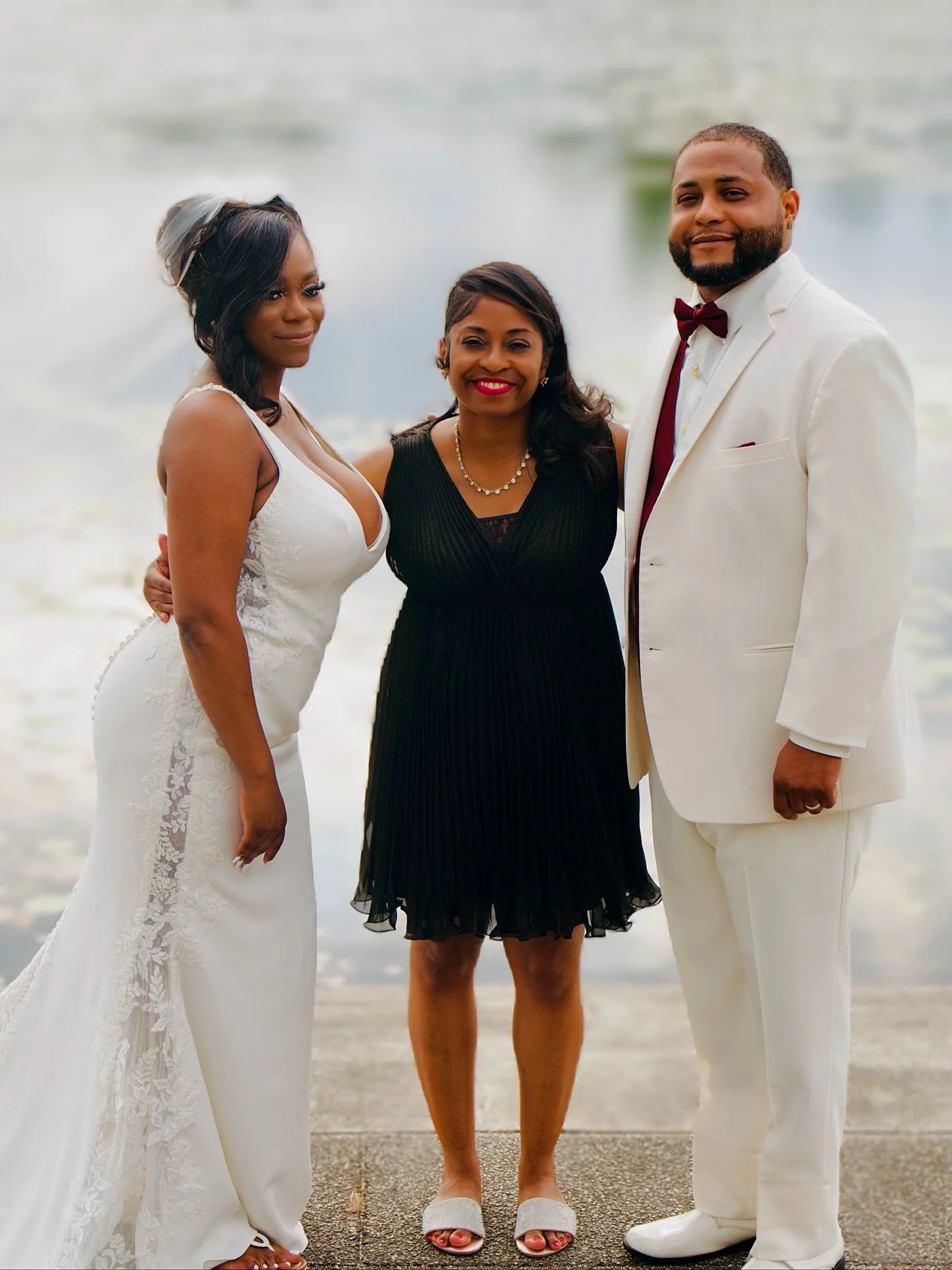 Laurie’s customers, Mariana and Carmen holding hands on a green lawn on their wedding day.