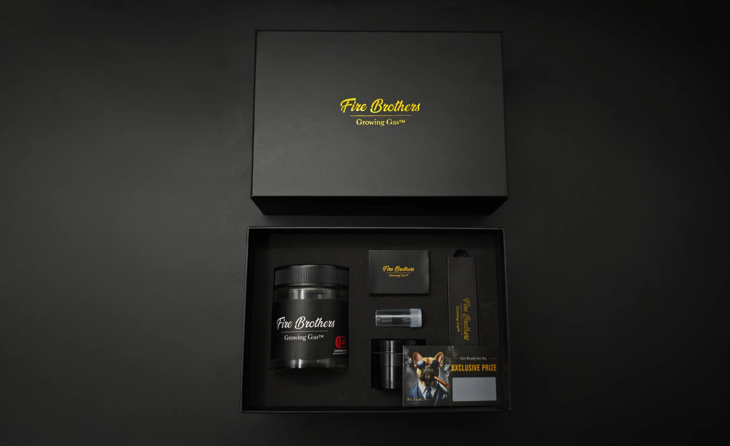 Custom cannabis smoker's pack gift box with branded rolling papers, grinder, glass filter tips and matches
