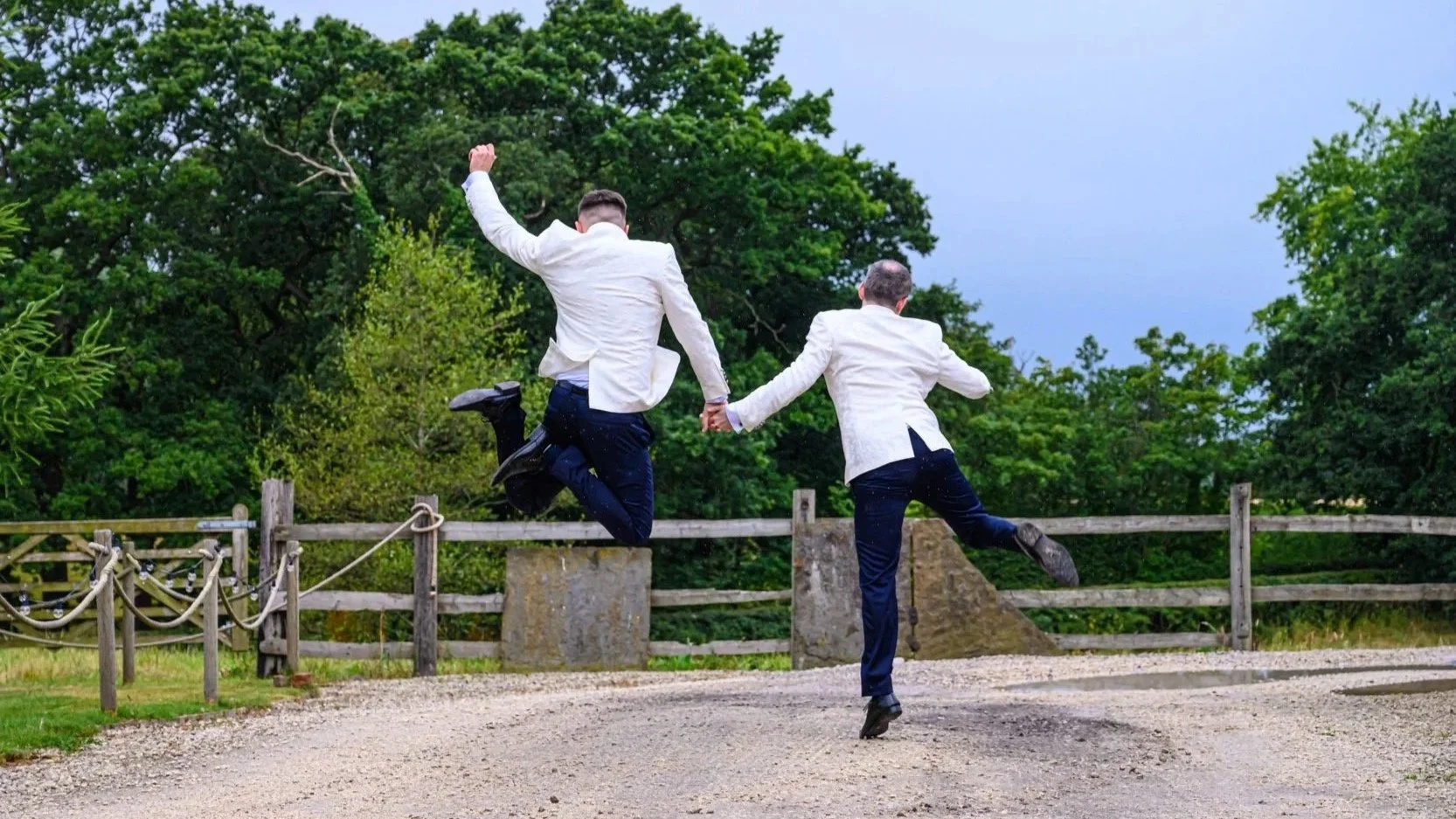 gay couple - grooms on their wedding day - heel clicking - lgbtq wedding photography of two grooms being fabulous