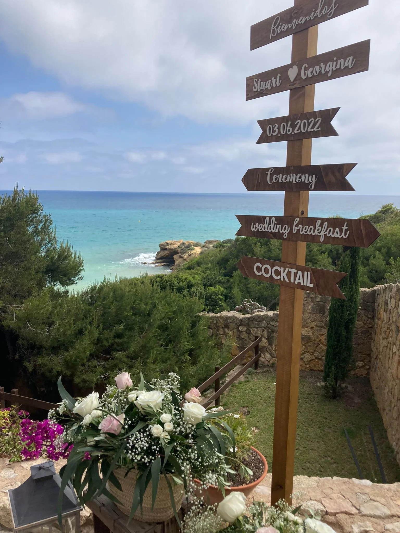 An image of an intimate beach wedding with flowers in the foreground