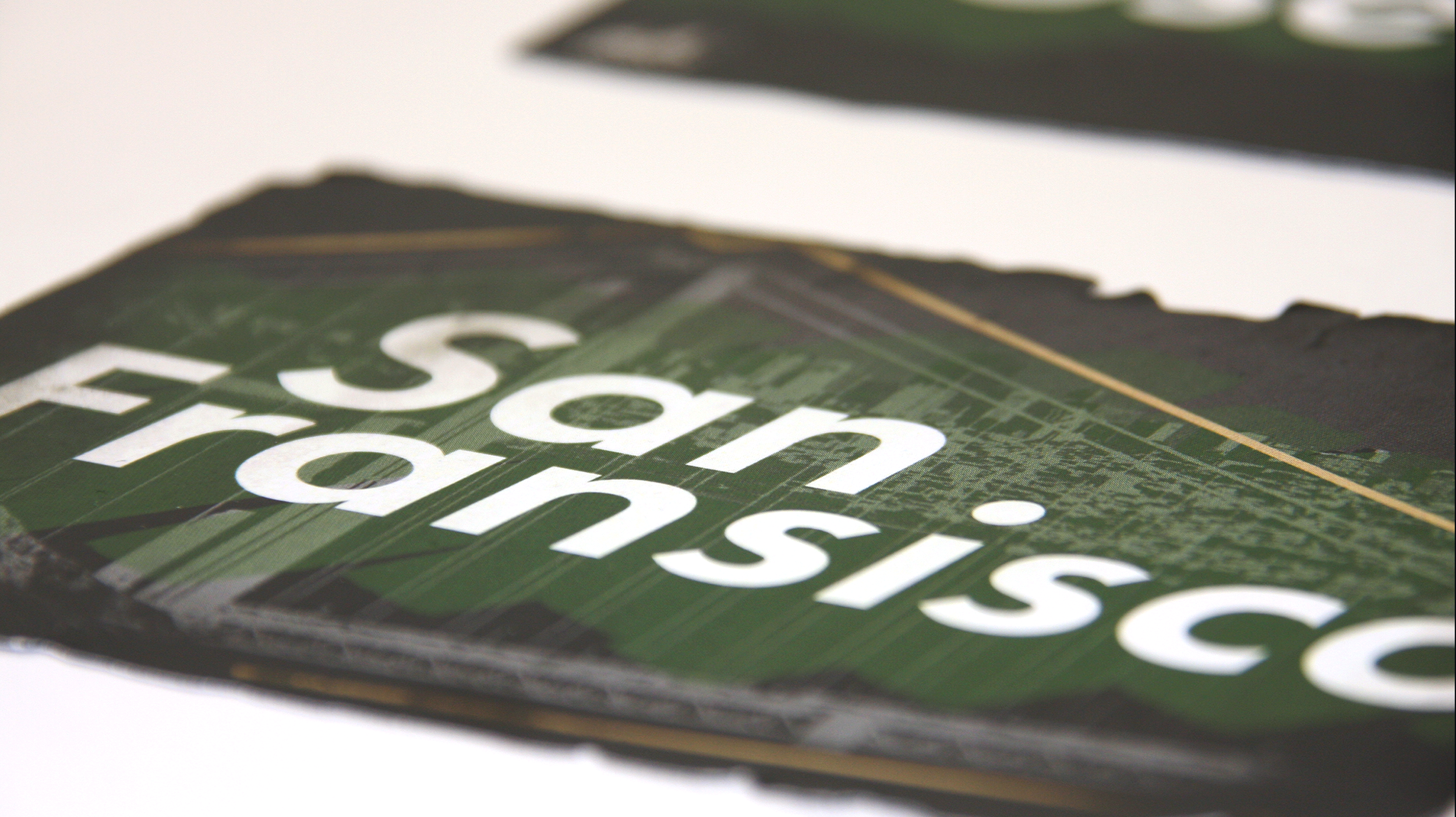 close up of burned post cards on a grey background