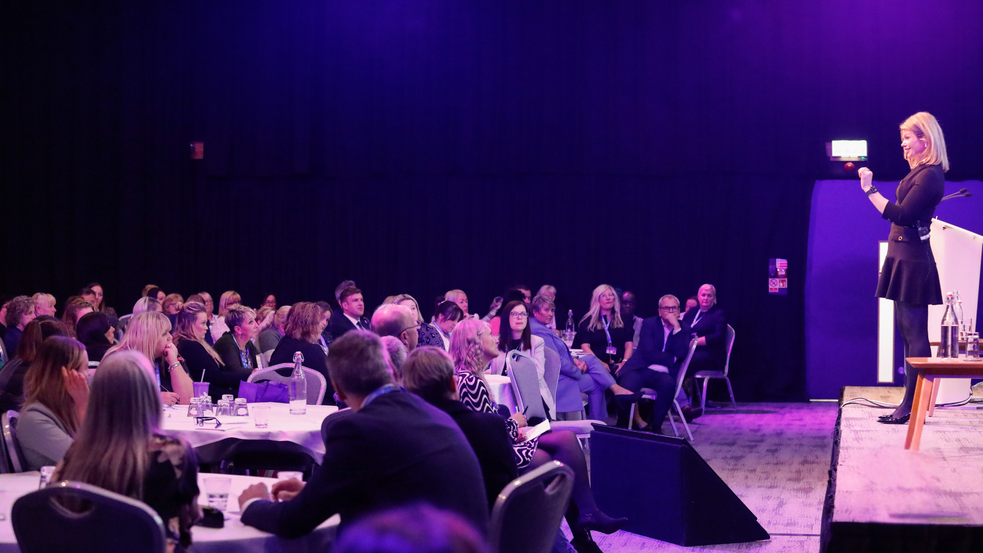 An image of Dani giving a speech to an engaged crowd