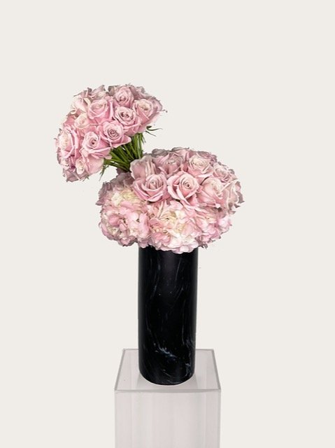 The "Pink" arrangement features light pink hydrangea with a mix of light pink roses. The arragements come in tall cylinder.