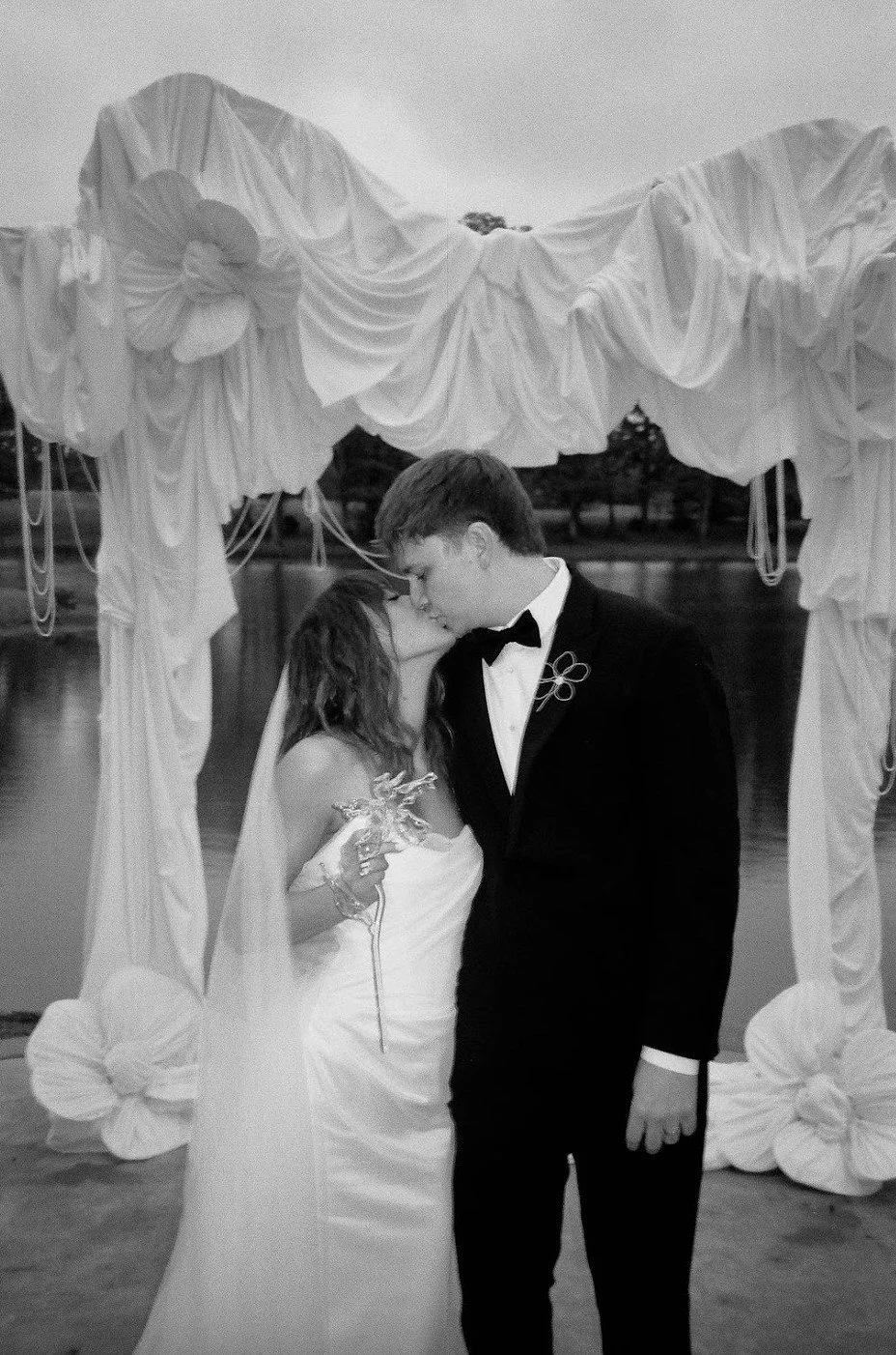 Bride and groom beneath a draped outdoor ceremony altar at The Eden Estate. Photo by Jenna York.