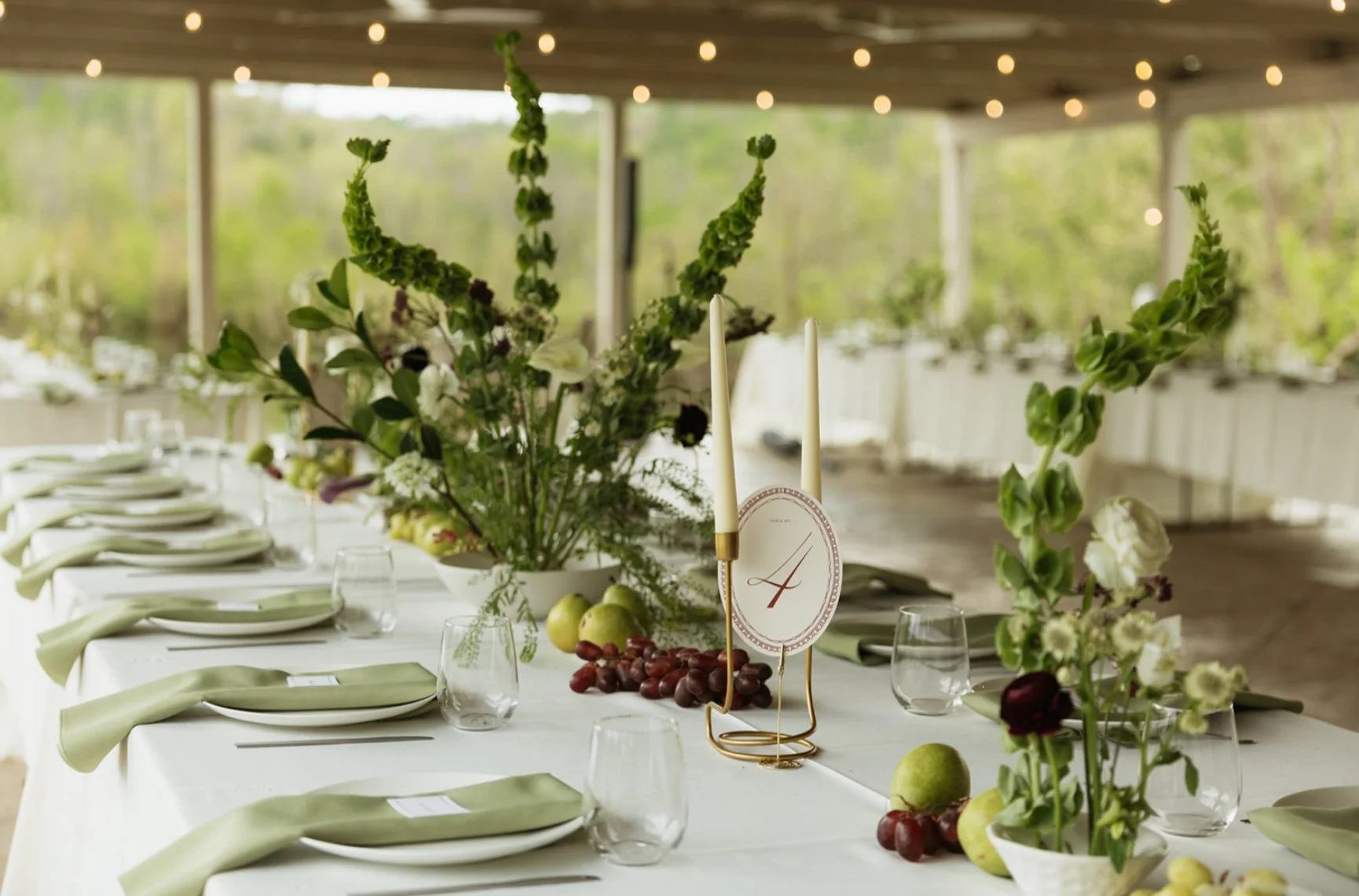 Wedding reception table setting with white flowers and candles in The Eden Estate Pavilion.