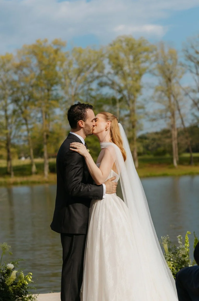 Bride and groom sharing a portrait beside the lake at The Eden Estate.