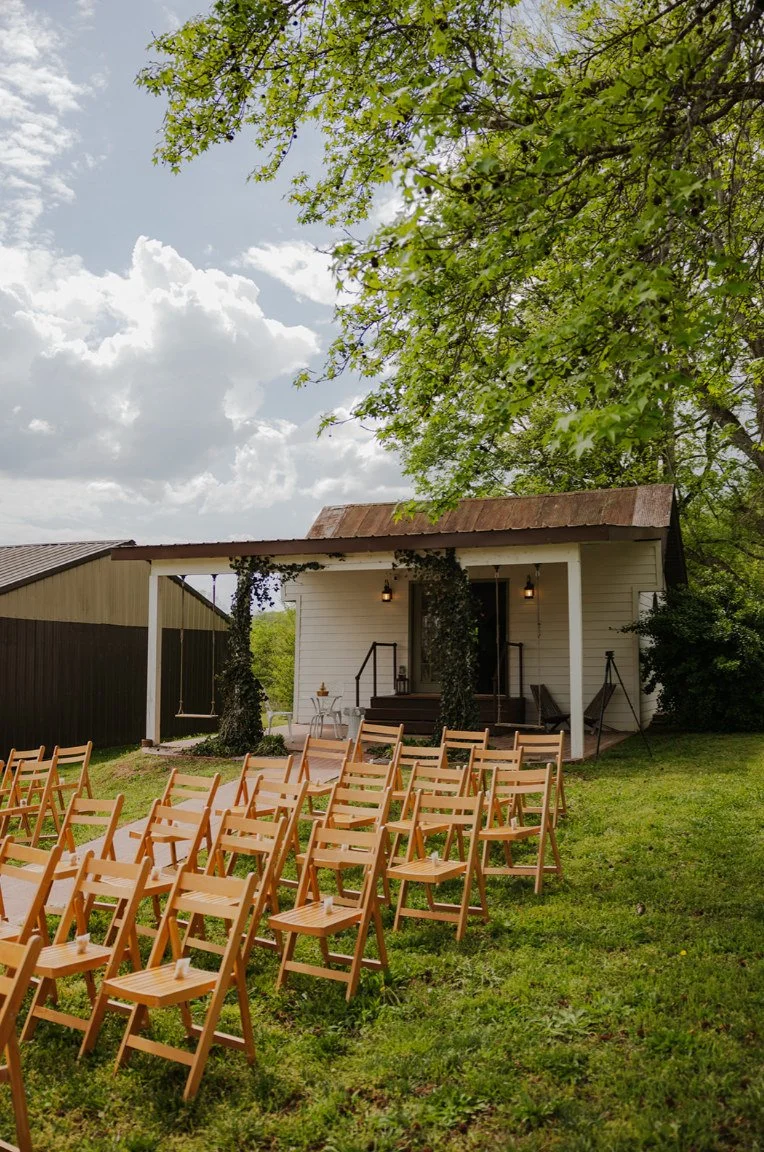 Outdoor ceremony seating beneath the trees near the historic inn at The Eden Estate.