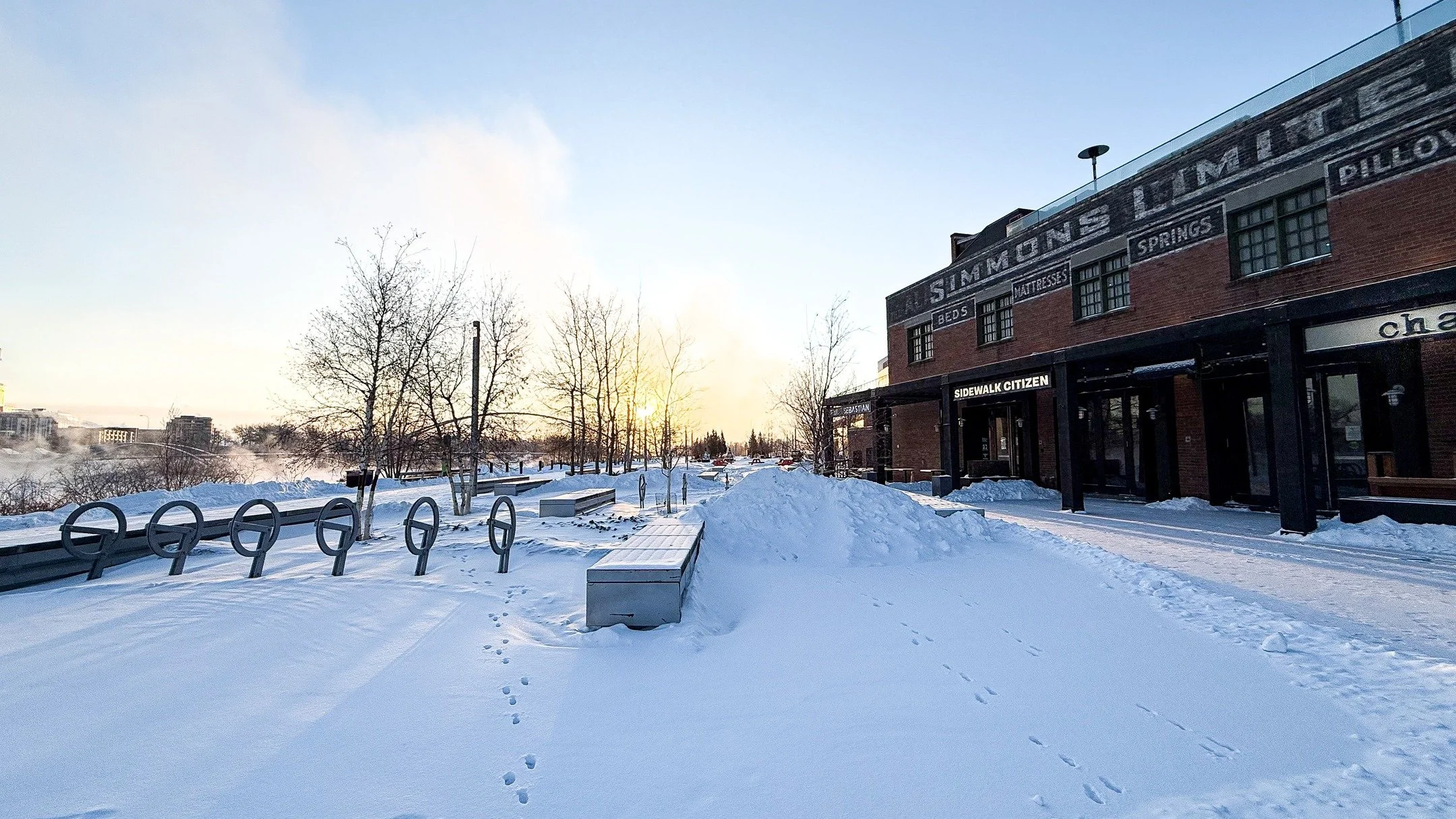 Snow piled high, the river steaming in the cold, and the ovens warm inside - the morning sun just hits different in the frosty sunlight. 
Winter in the Simmons Building means fresh sourdough, nourishing meals, and a place to thaw out.
Come in from th