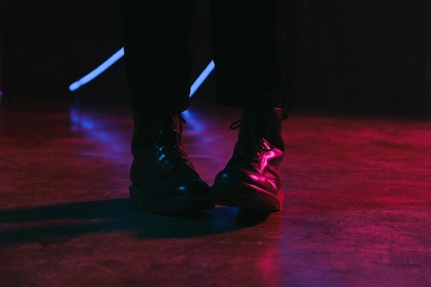 A person’s Doc Martin boots awkwardly positioned with one foot over the other, symbolizing hesitation and the tentative steps of working through social anxiety.