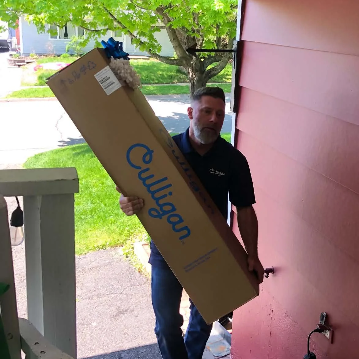 Culligan of Fredericton Service Technician removing equipment to install from Van. 
