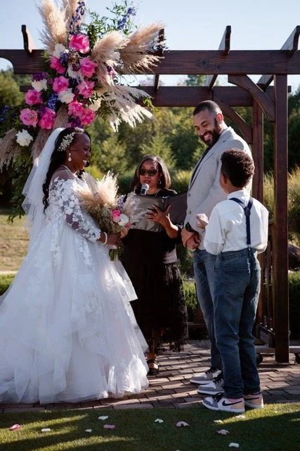 In an elegant southern setting at the Scarritt Bennett Mansion, the bride shares a joyful laugh with her groom while holding a stunning bouquet.