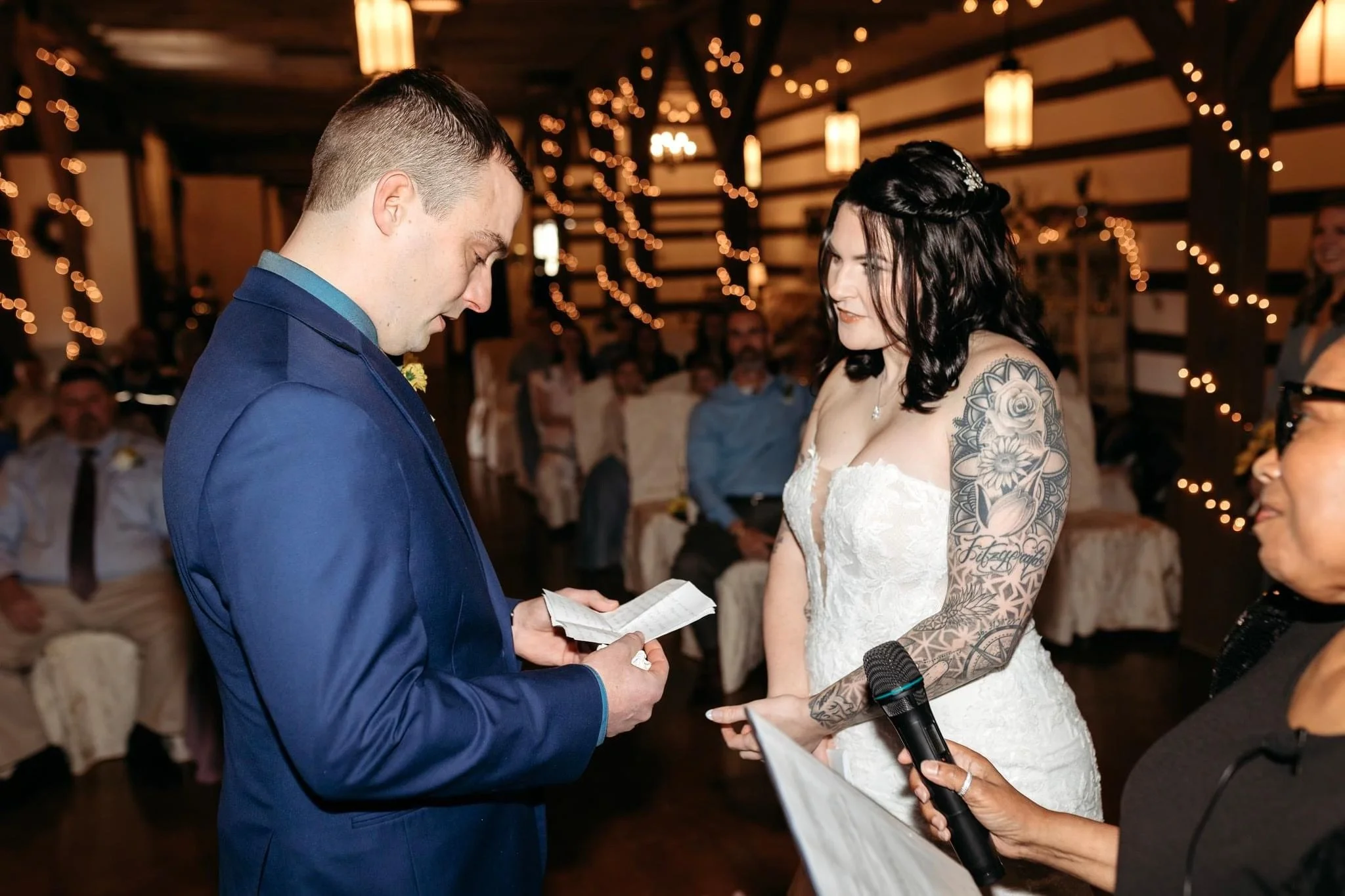 At the Liberty Stables the groom reads his wedding vows to his bride.