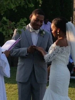 The groom places the ring on the brides finger at the wedding ceremony held at OZ Arts Nashville.