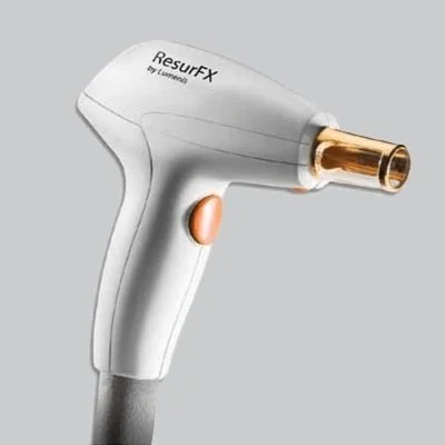 A white ResurfX medical device with a gold-colored treatment tip and an orange button, designed for skin treatment.