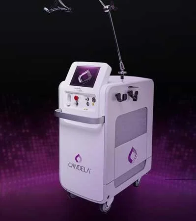 Medical device labeled Candela with a digital screen and equipment attached, used for cosmetic or dermatological treatments, on a dark purple background.