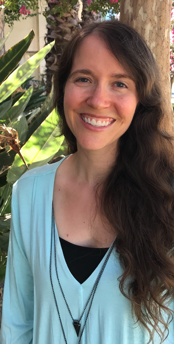 Alyssa the therapist, with brown hair and wearing a light aqua shirt and smiling