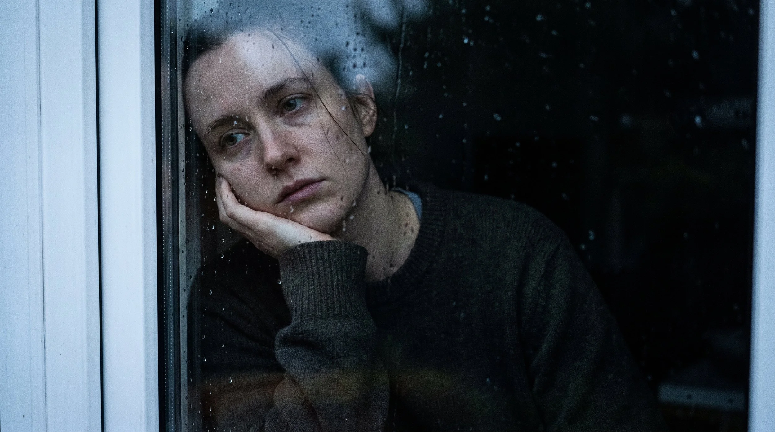 person experiencing emotional numbness and dissociation staring out window